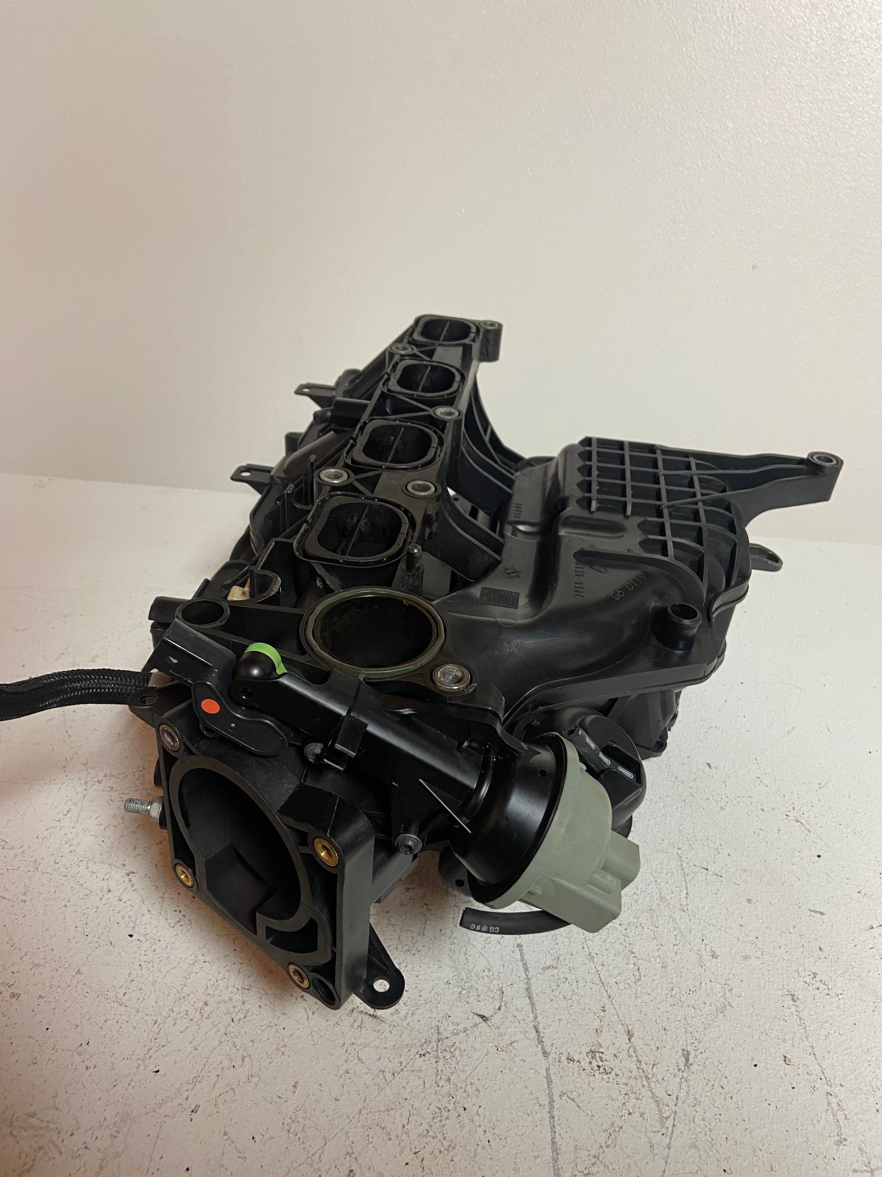 Engine air intake manifold side view with throttle body and sensor ports