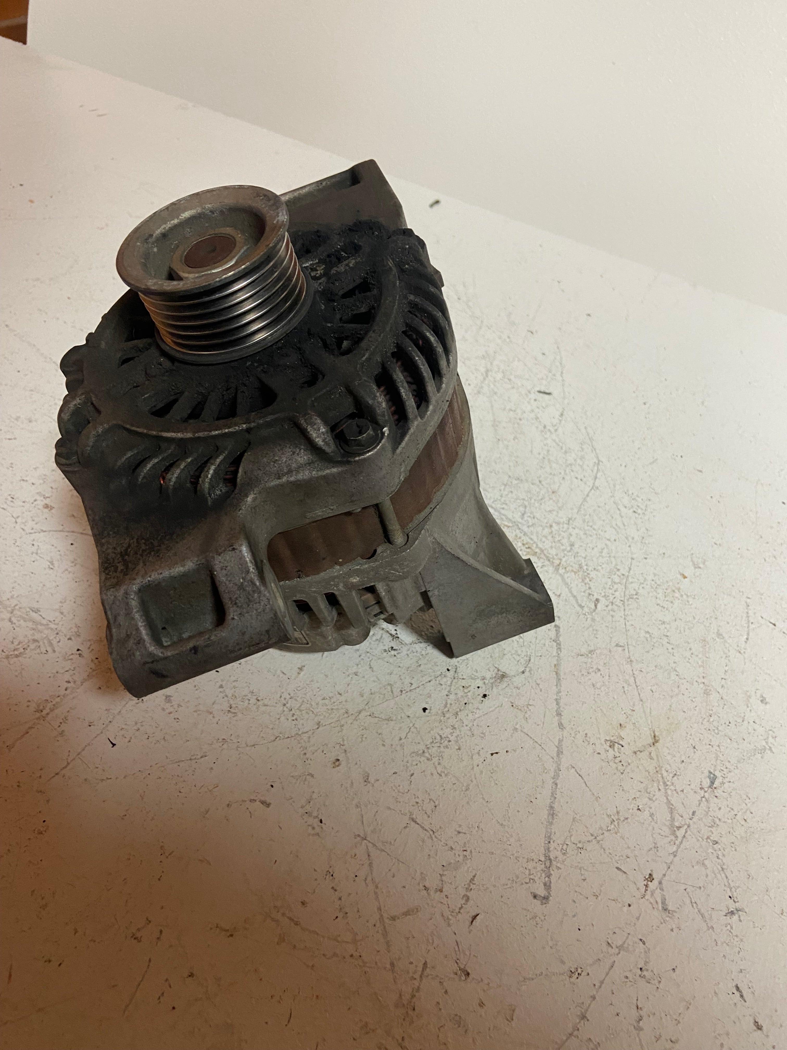 Gray alternator with threaded pulley opening and side mounts