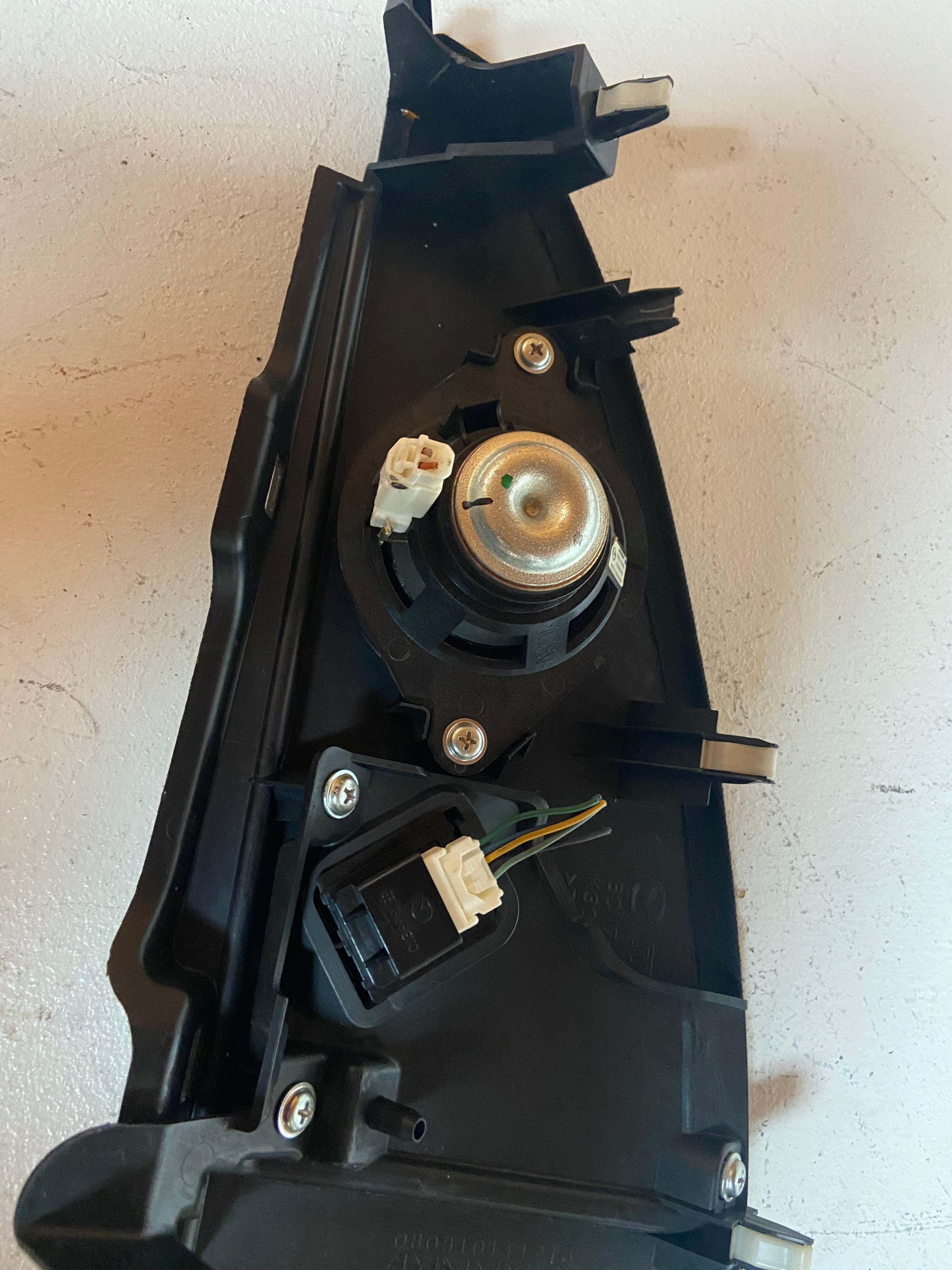 Back of dark instrument cluster trim bezel with mounting clips and connectors