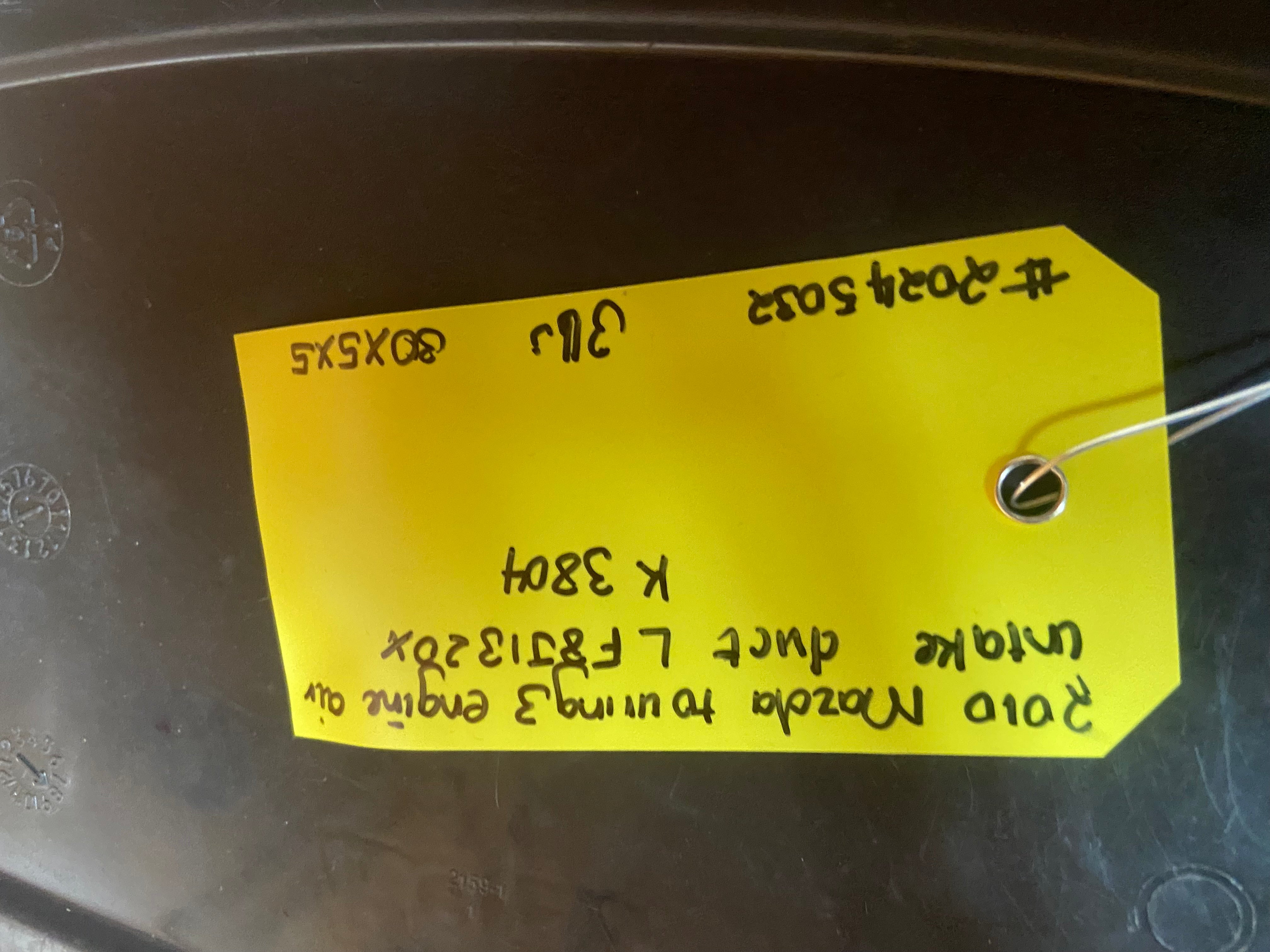 Yellow inventory label on engine air intake duct