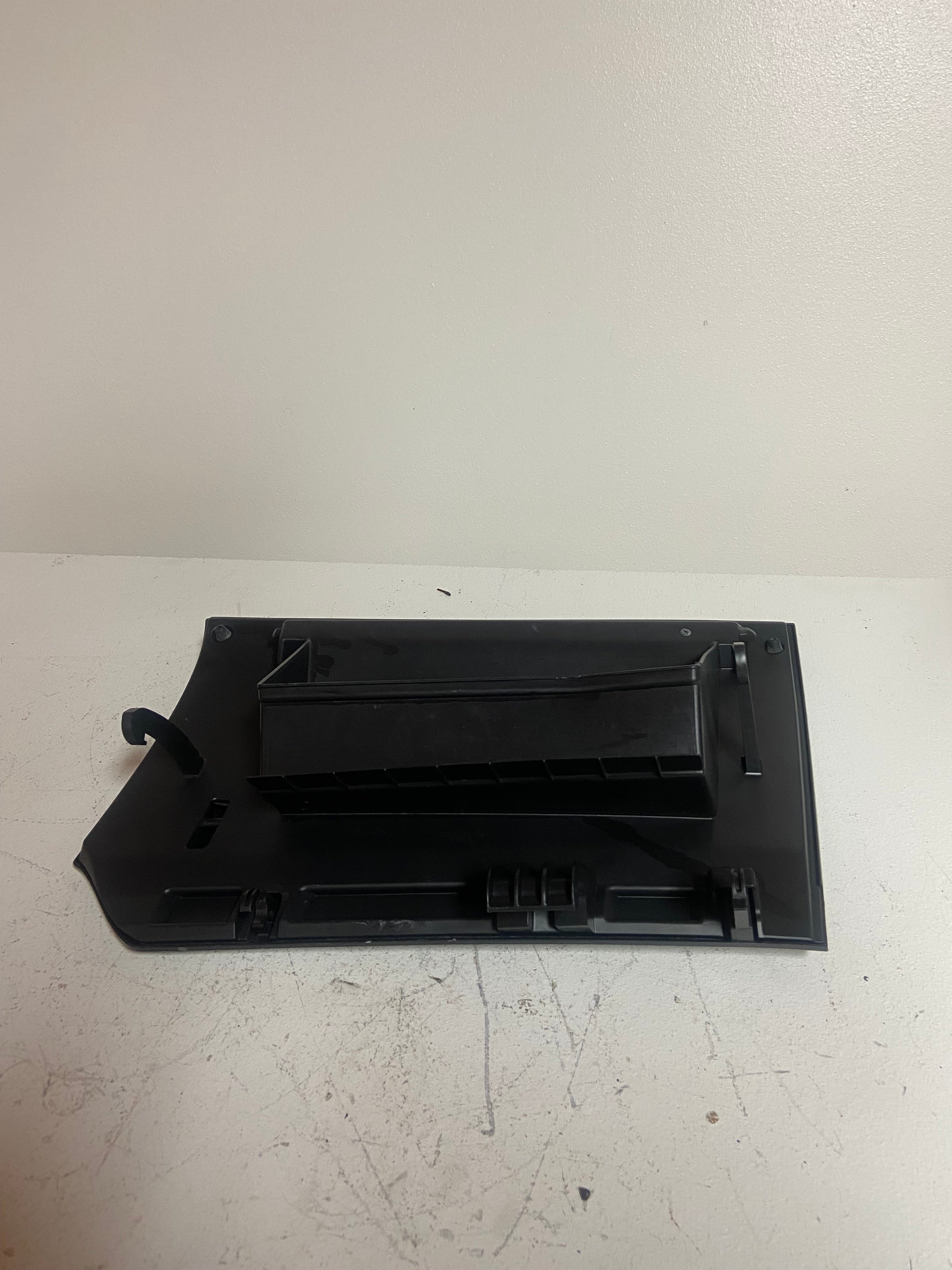 Black glove box lid underside with molded ribs and hinge hardware