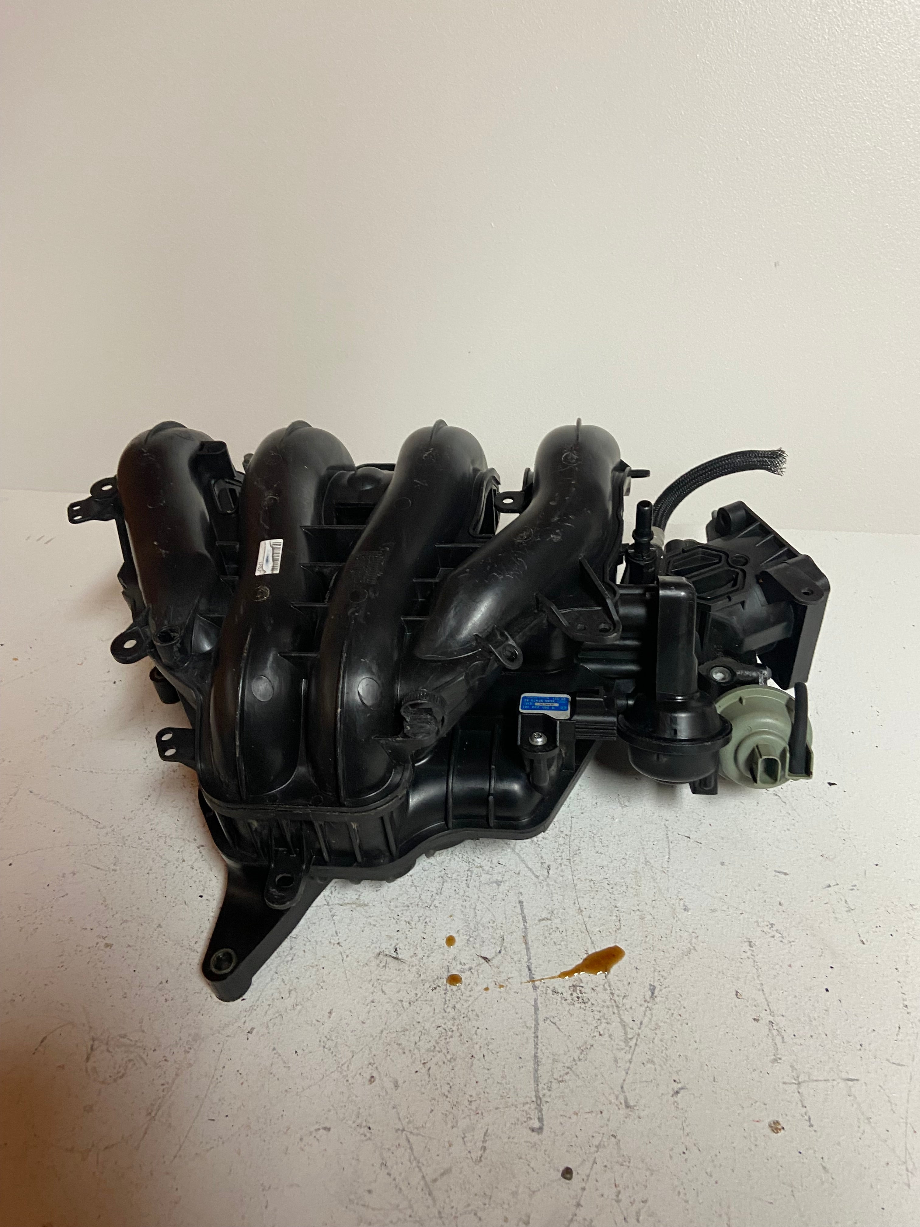 Engine air intake manifold assembly with multiple black intake runners and sensors