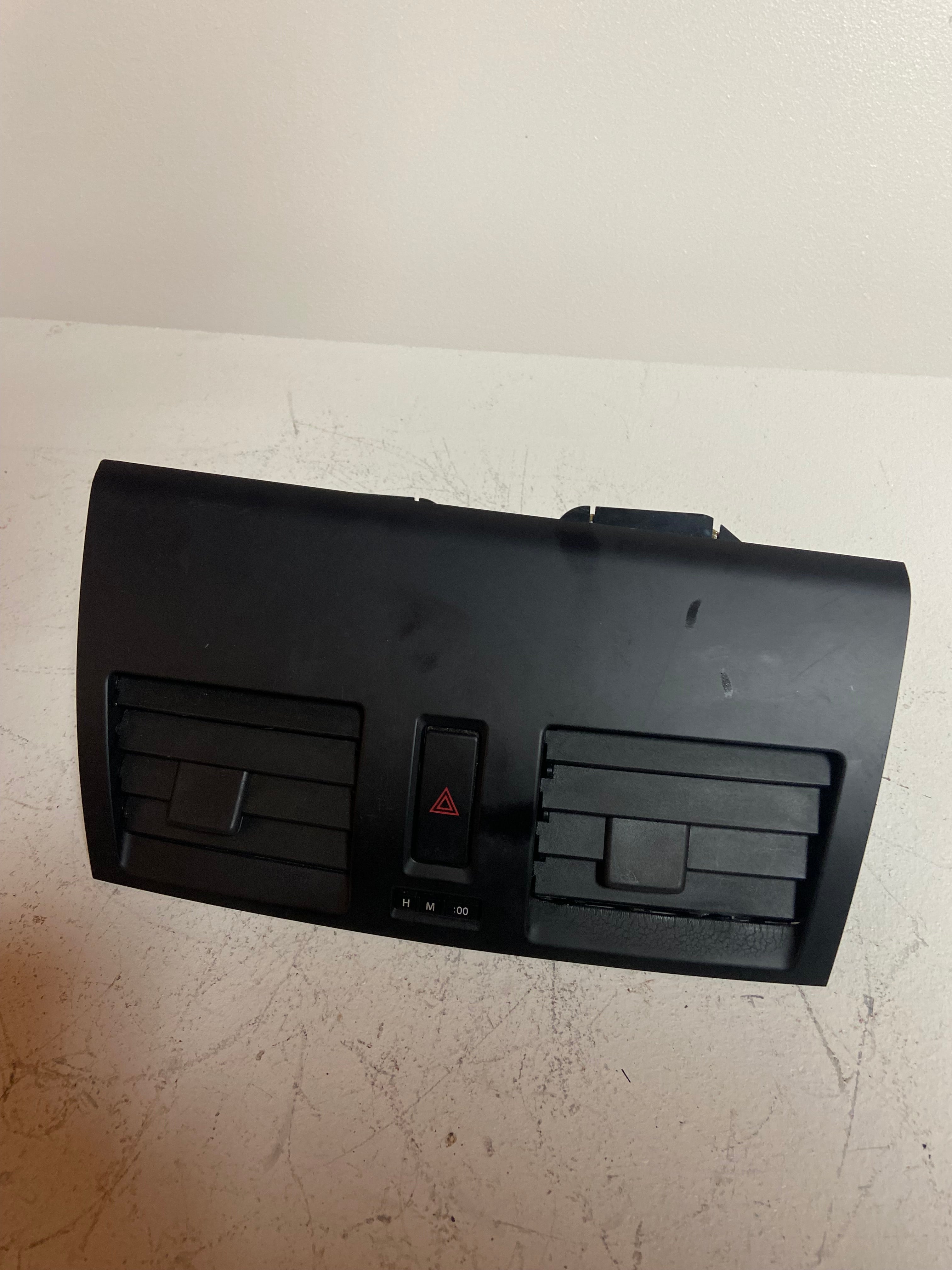 Center dashboard vent panel with hazard triangle switch and adjustable air vents