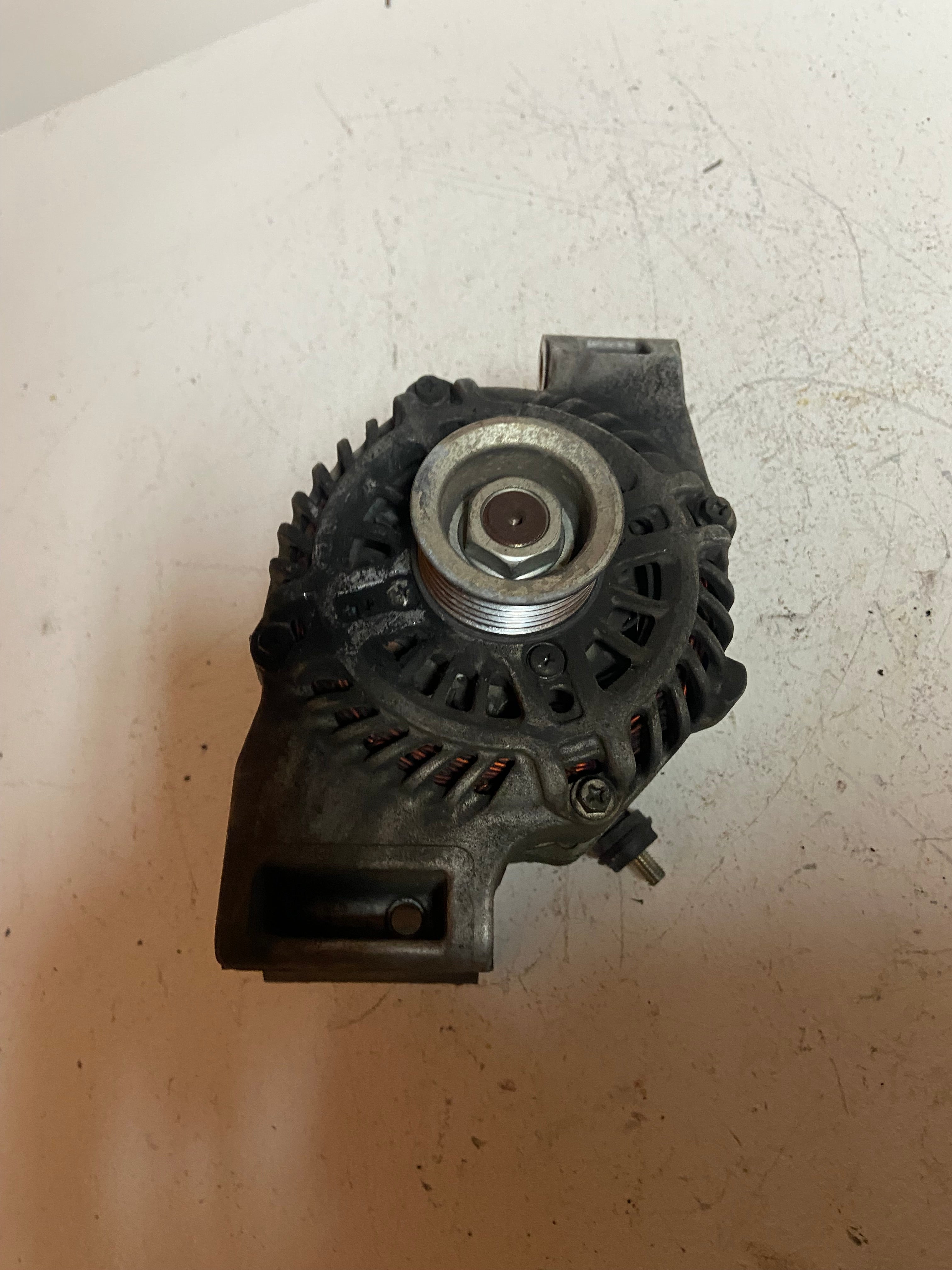 Alternator with central pulley and side housing connector, gray metal
