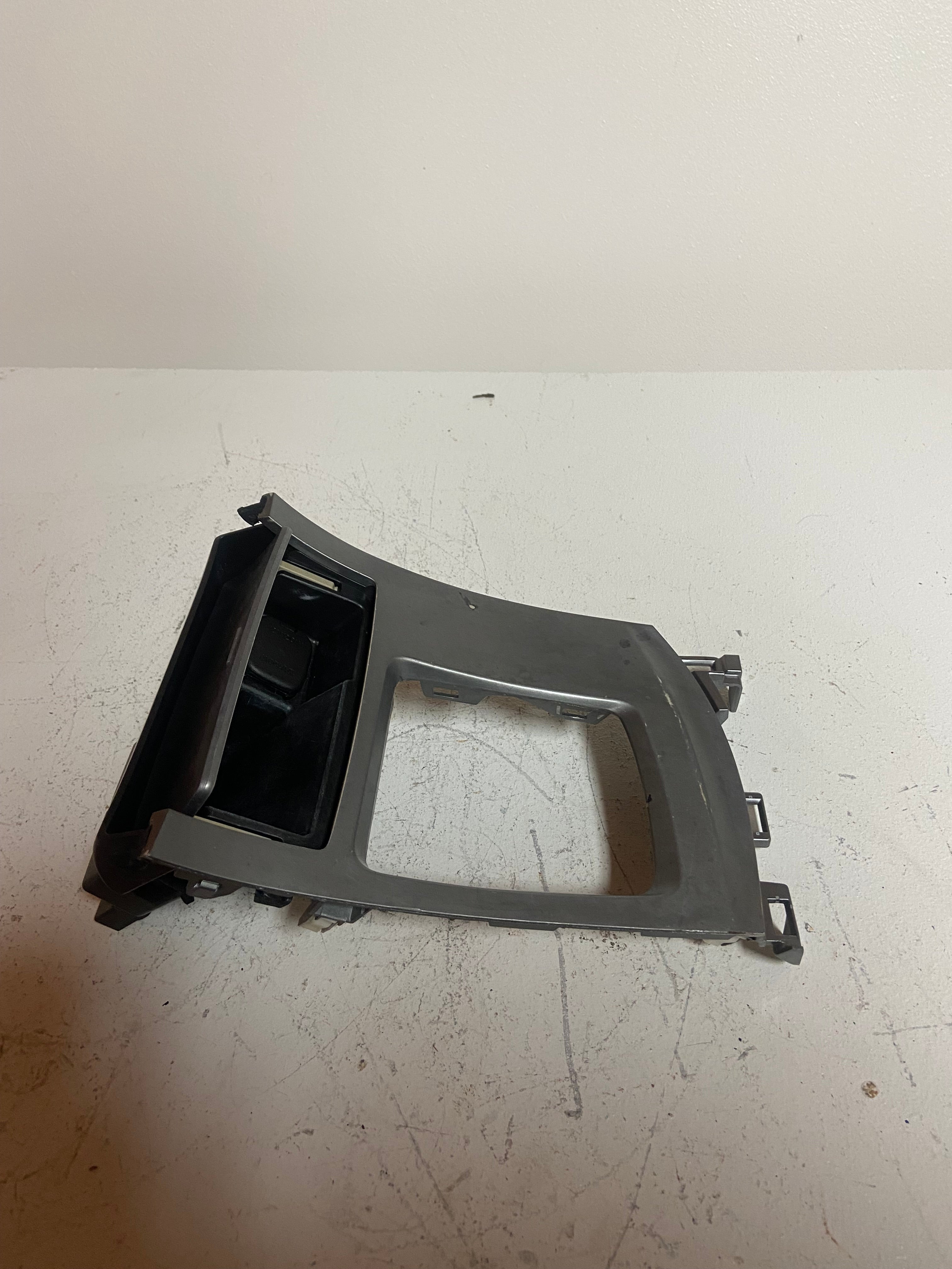 Silver and black shifter trim bezel side panel with open cutout