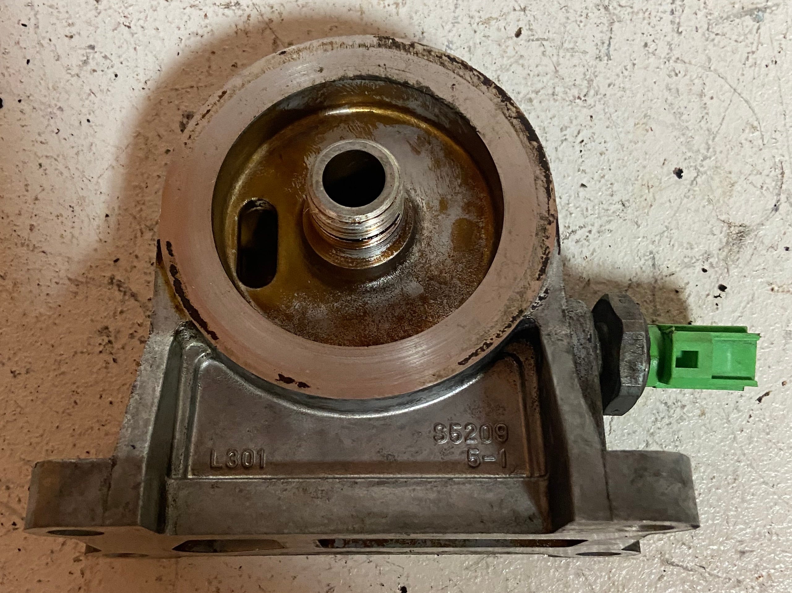 Engine oil filter adapter housing base with threaded port and green connector