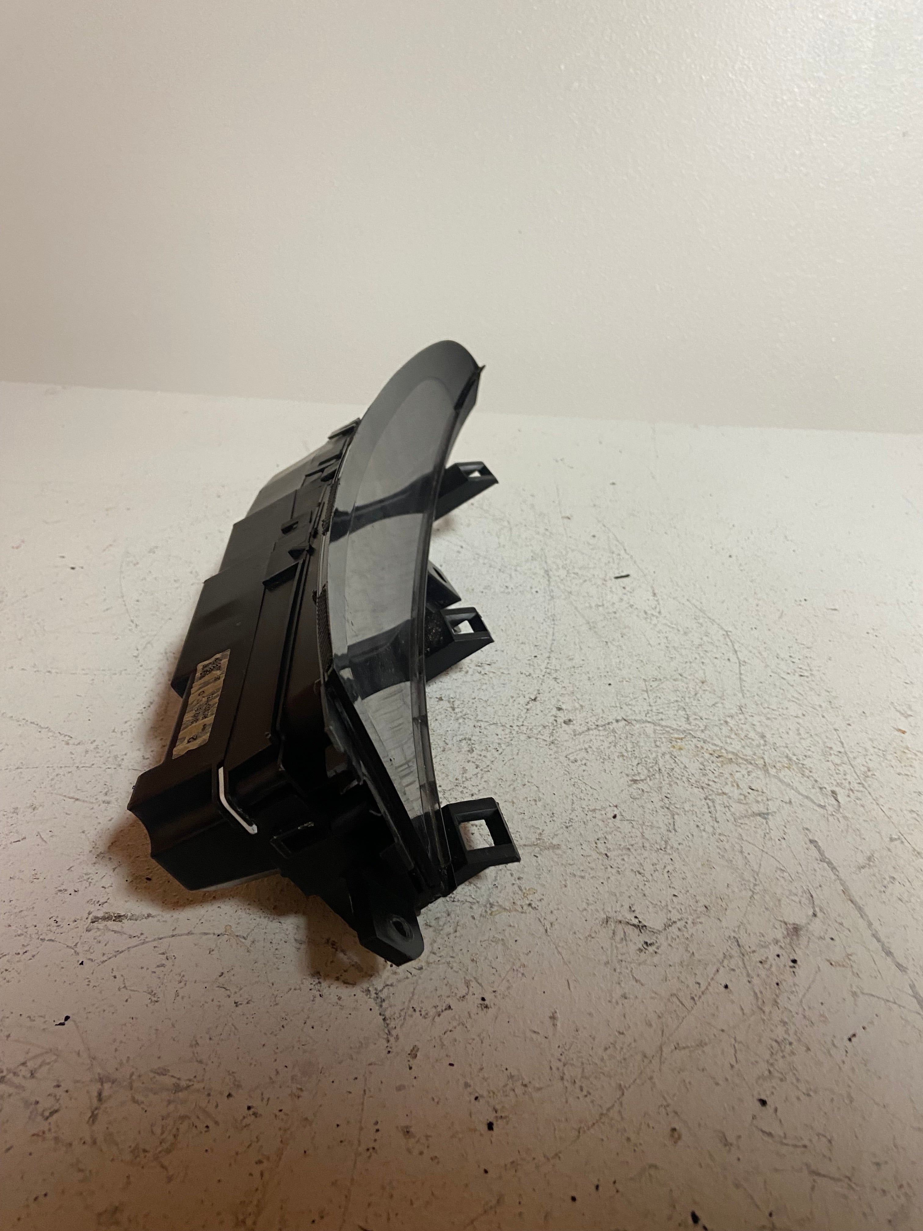 Black dash display screen housing with mounting clips and side bracket