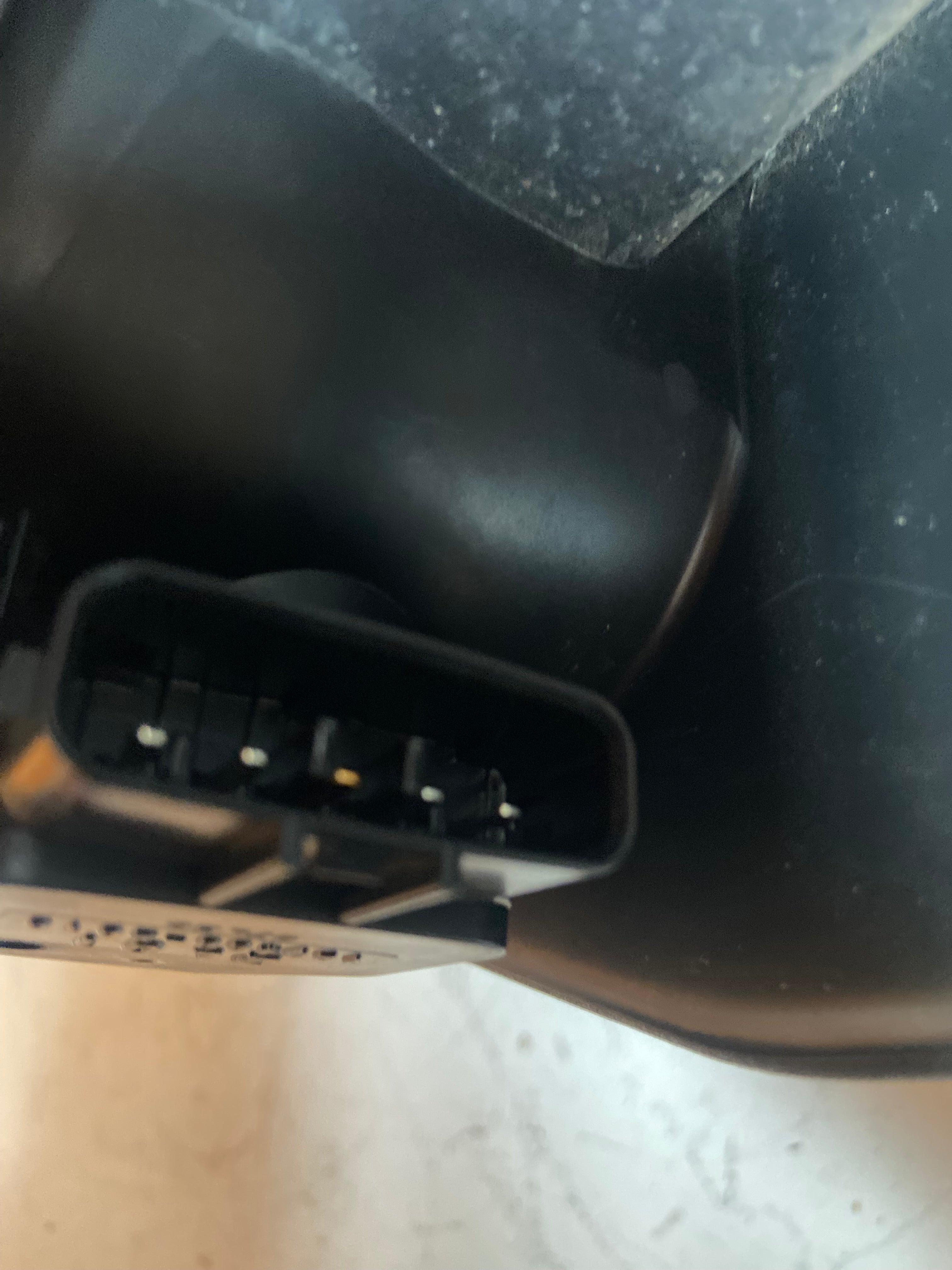 Air intake duct housing underside showing multi-pin electrical connector