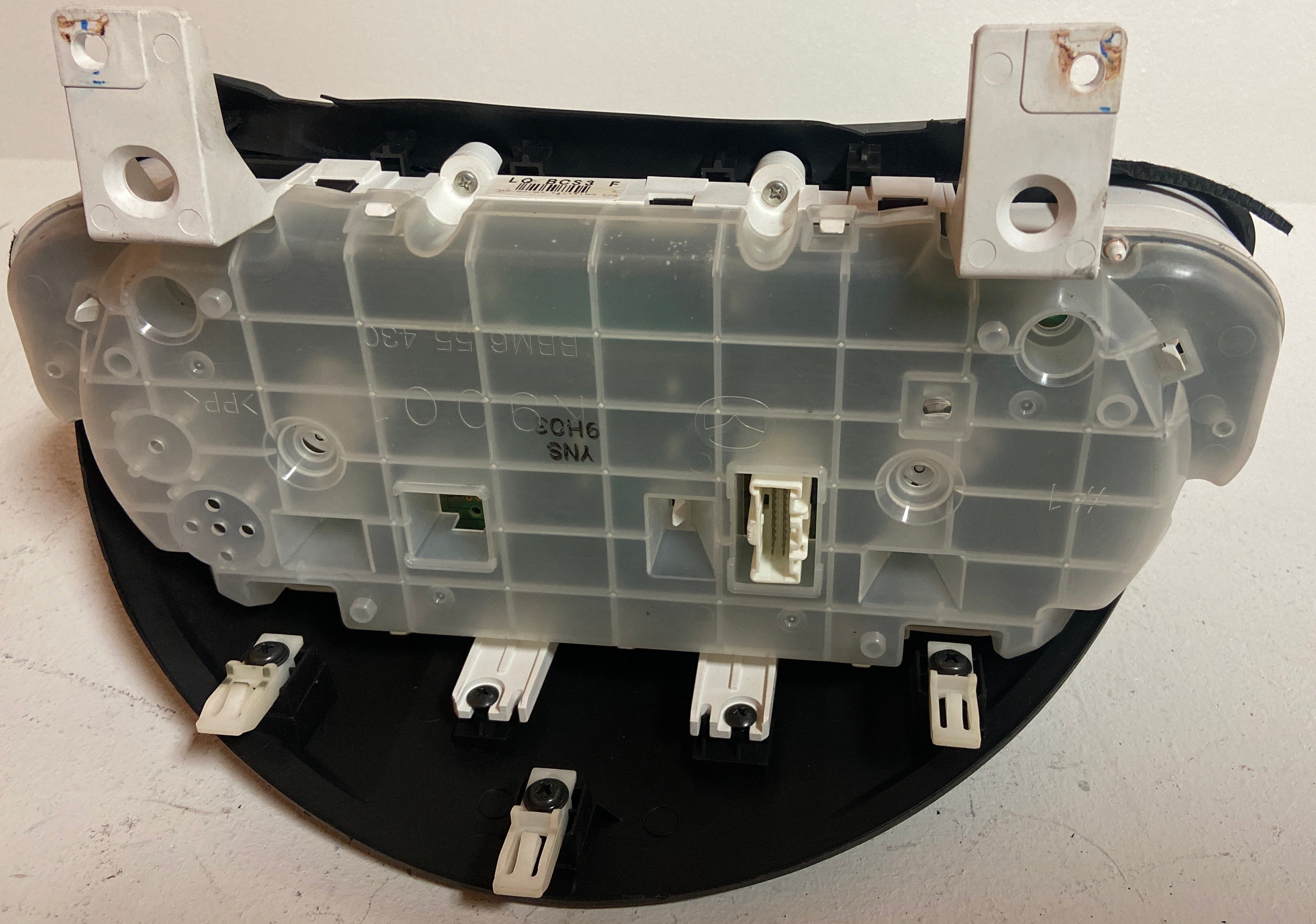 Vehicle instrument cluster back panel with connectors, sockets, and wiring ports