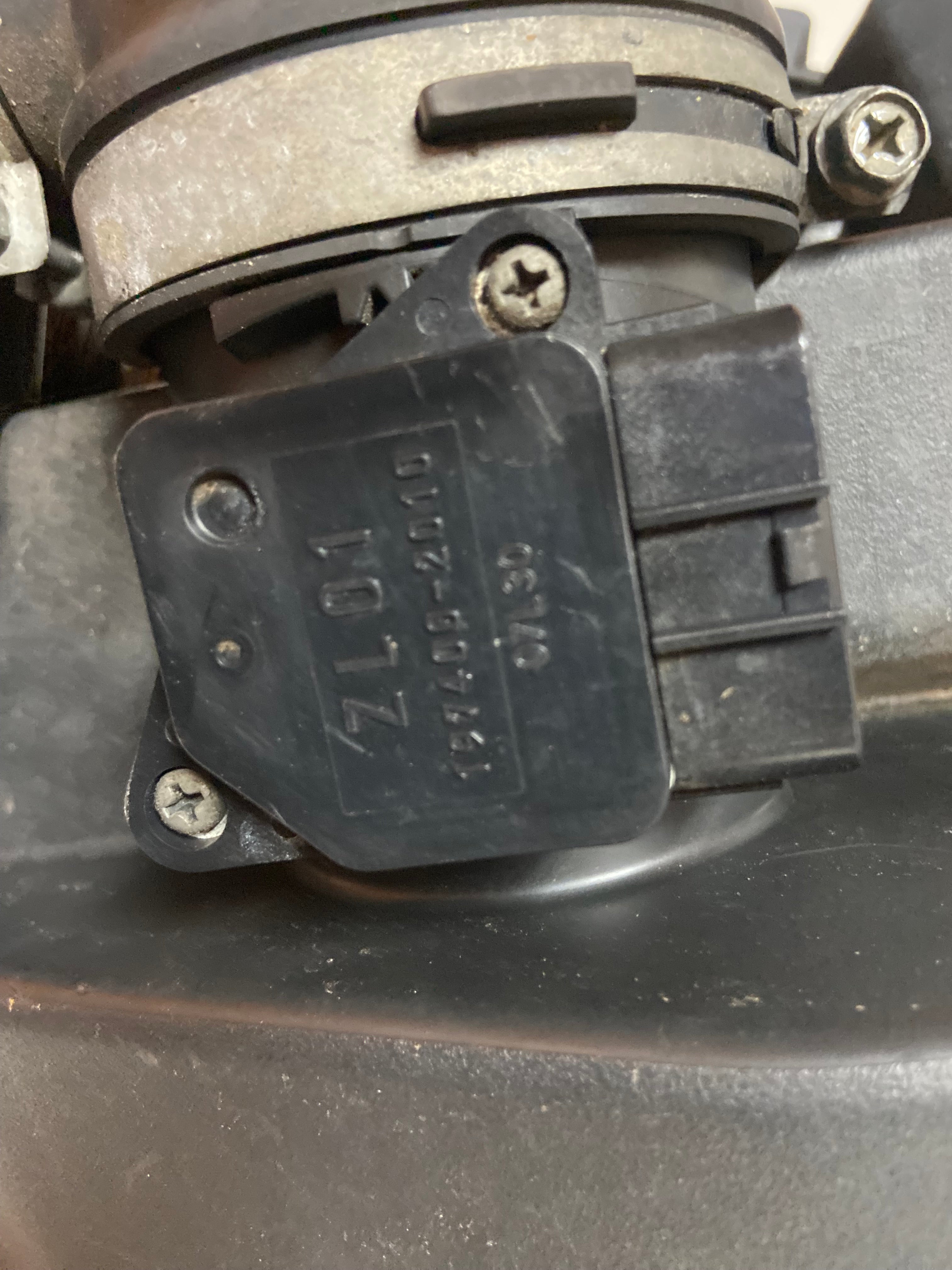 Air intake filter housing component with electrical connector and stamped label