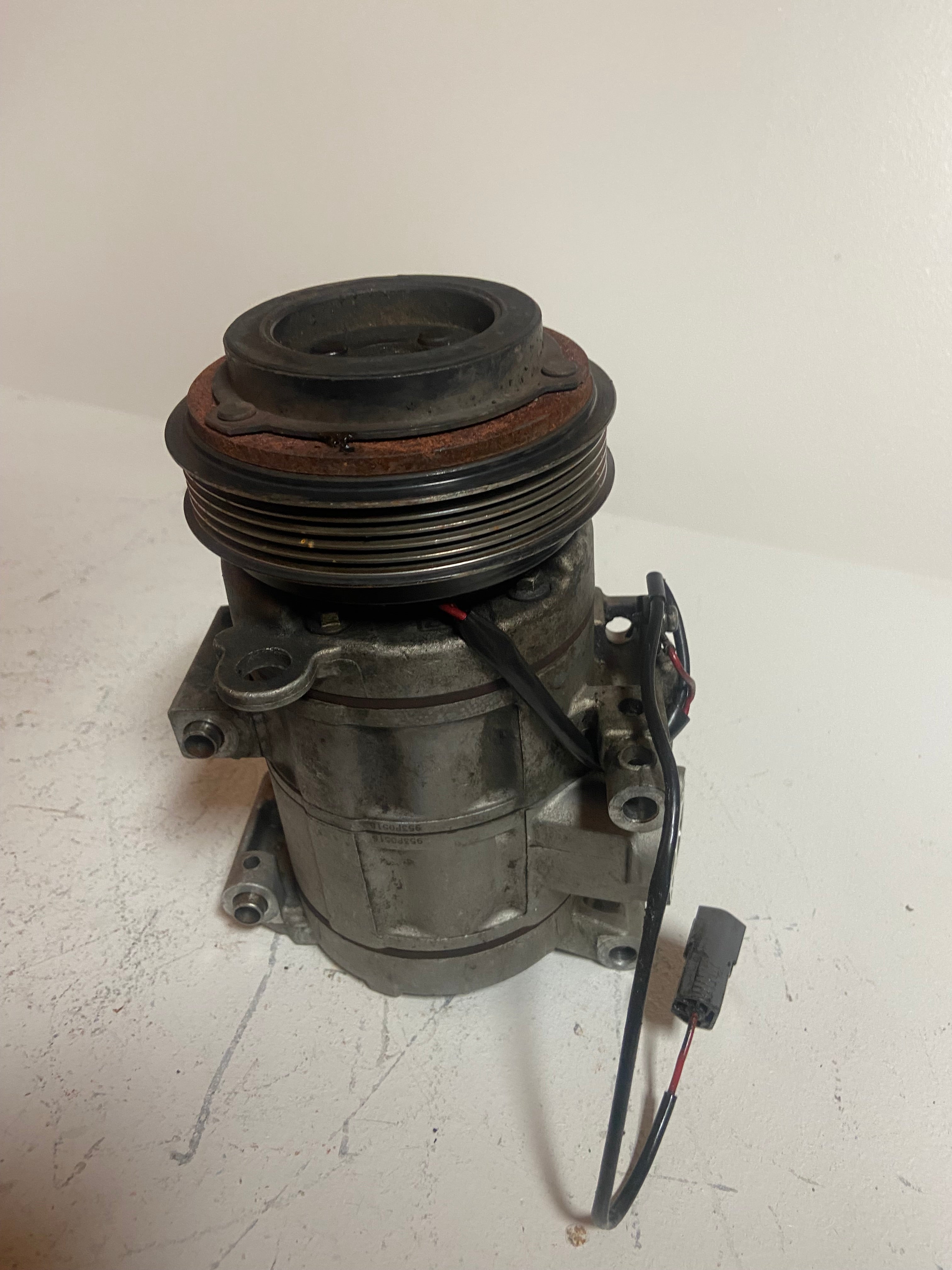 A/C compressor with pulley, bracketed base, and attached wiring
