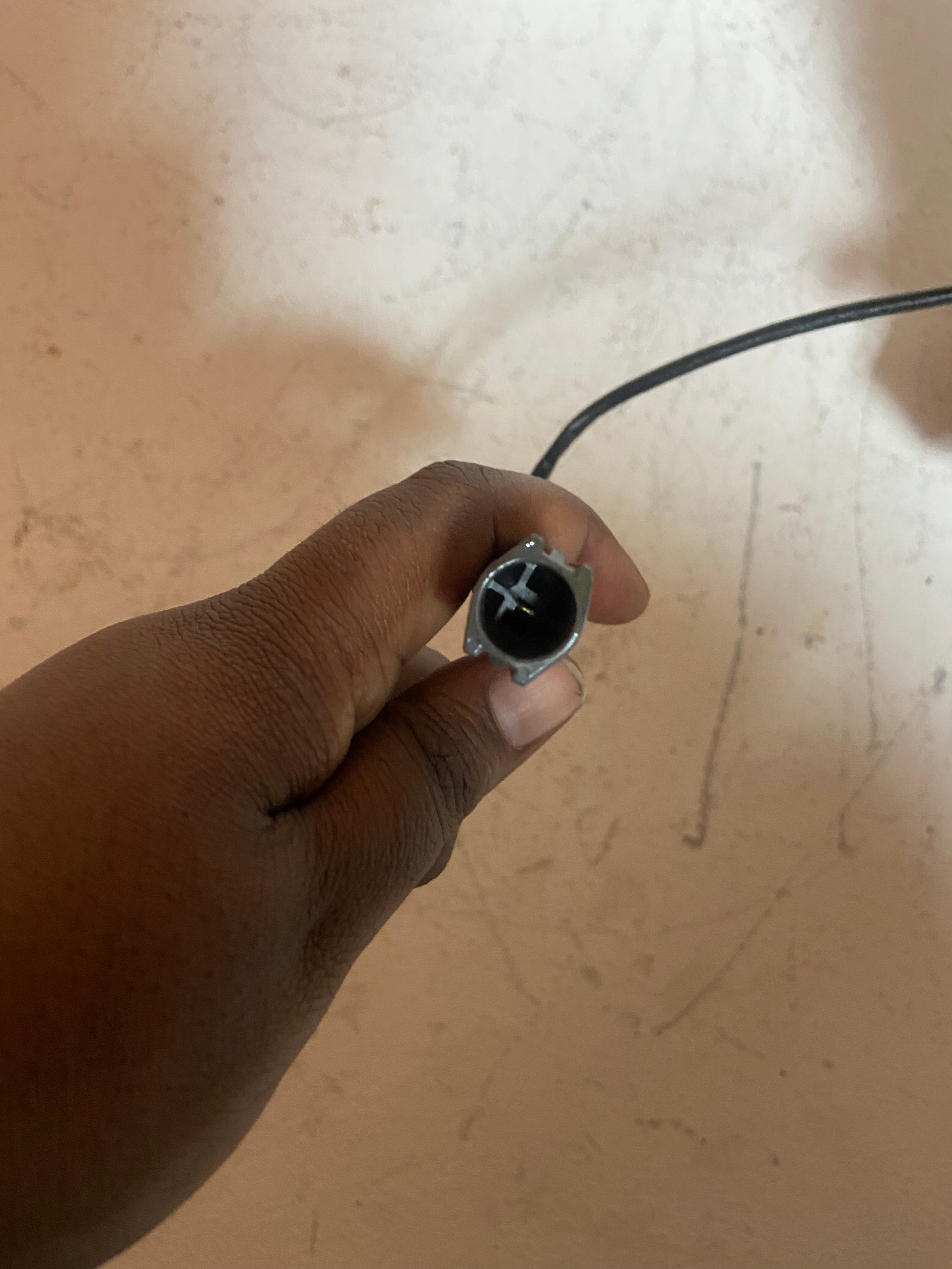 A/C compressor electrical connector plug held in a hand