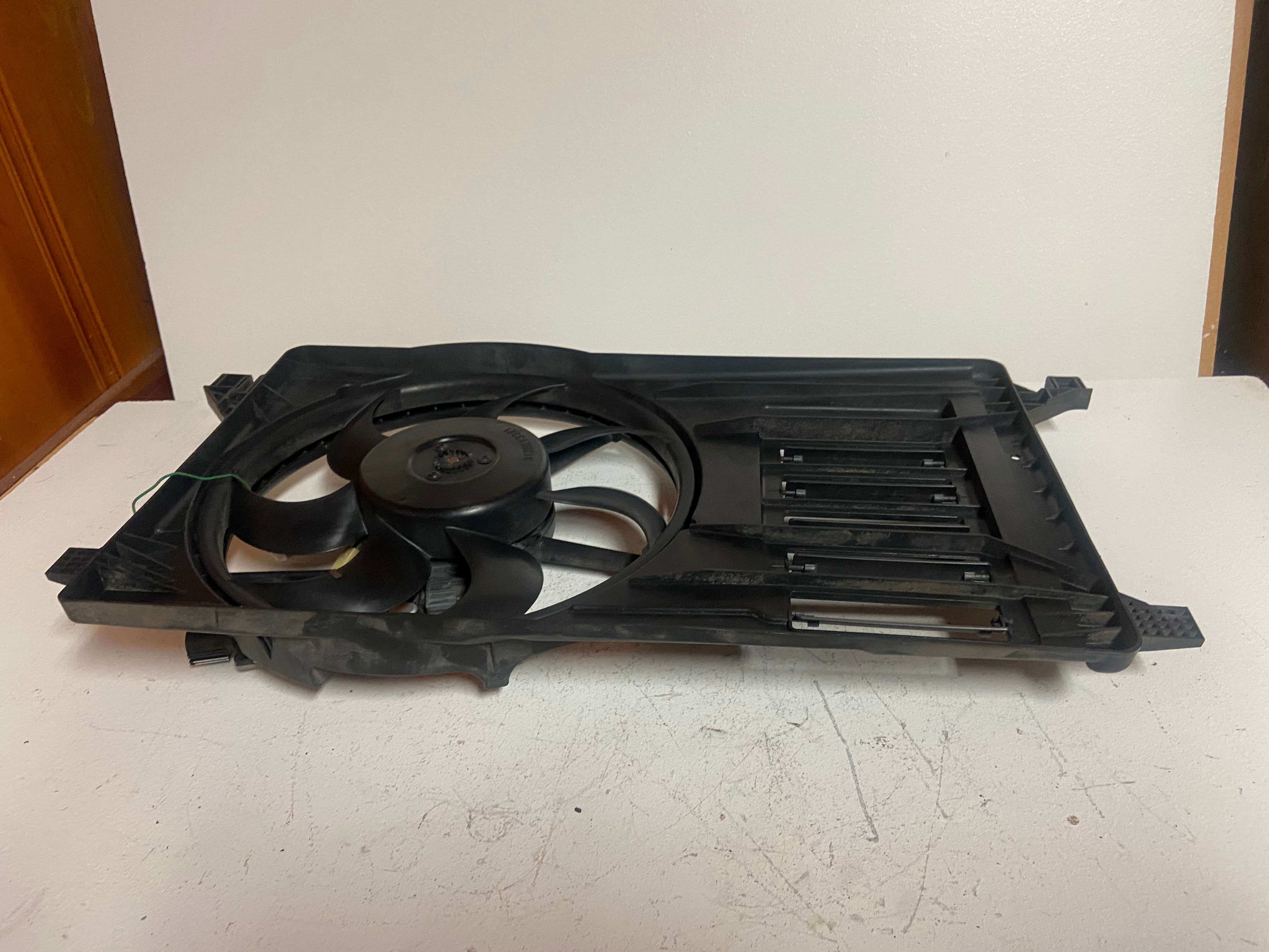 Electric radiator cooling fan assembly with mounted fan and ribbed plastic grille