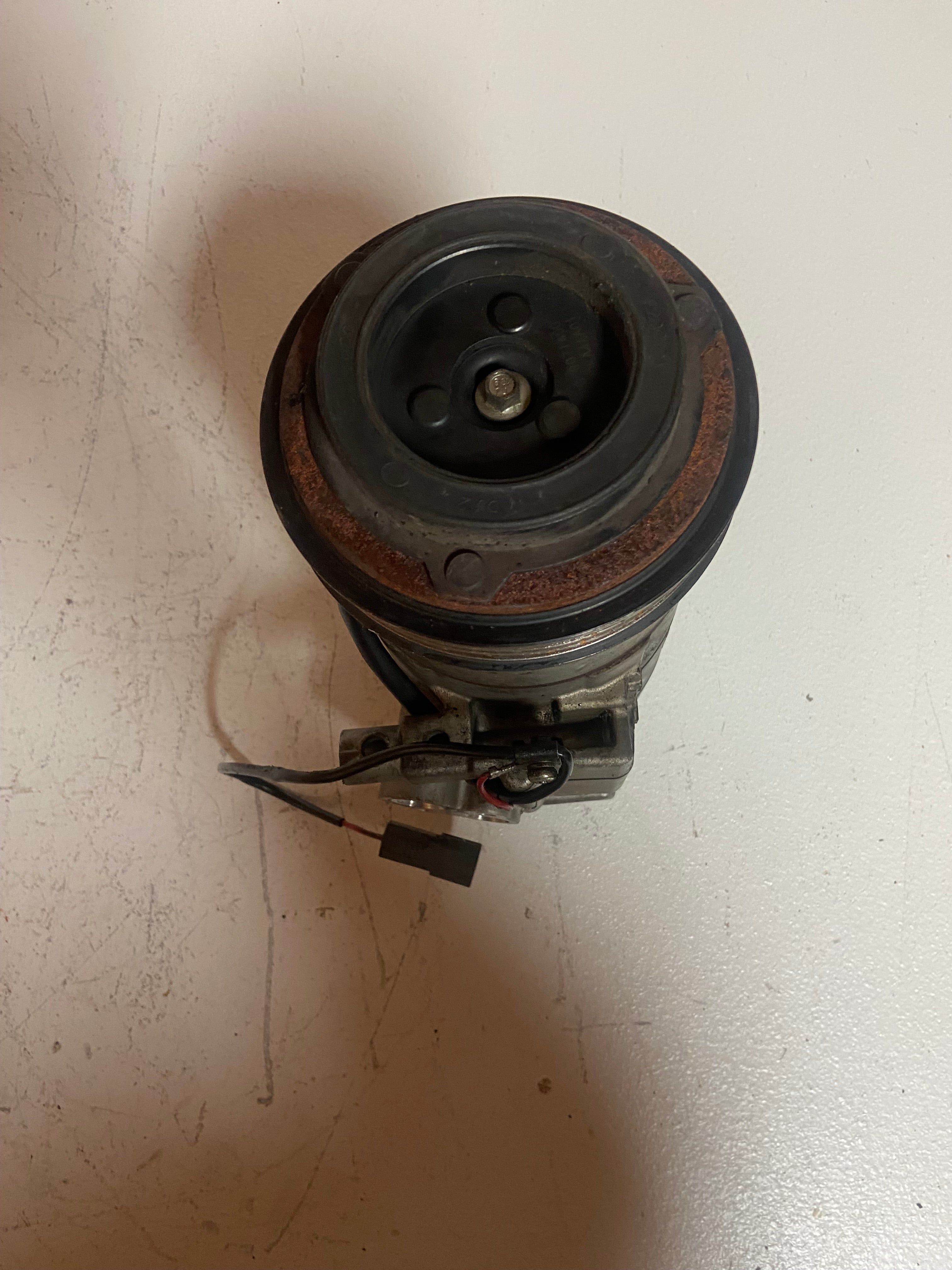 A/C compressor pulley end with rubber belt and central fitting