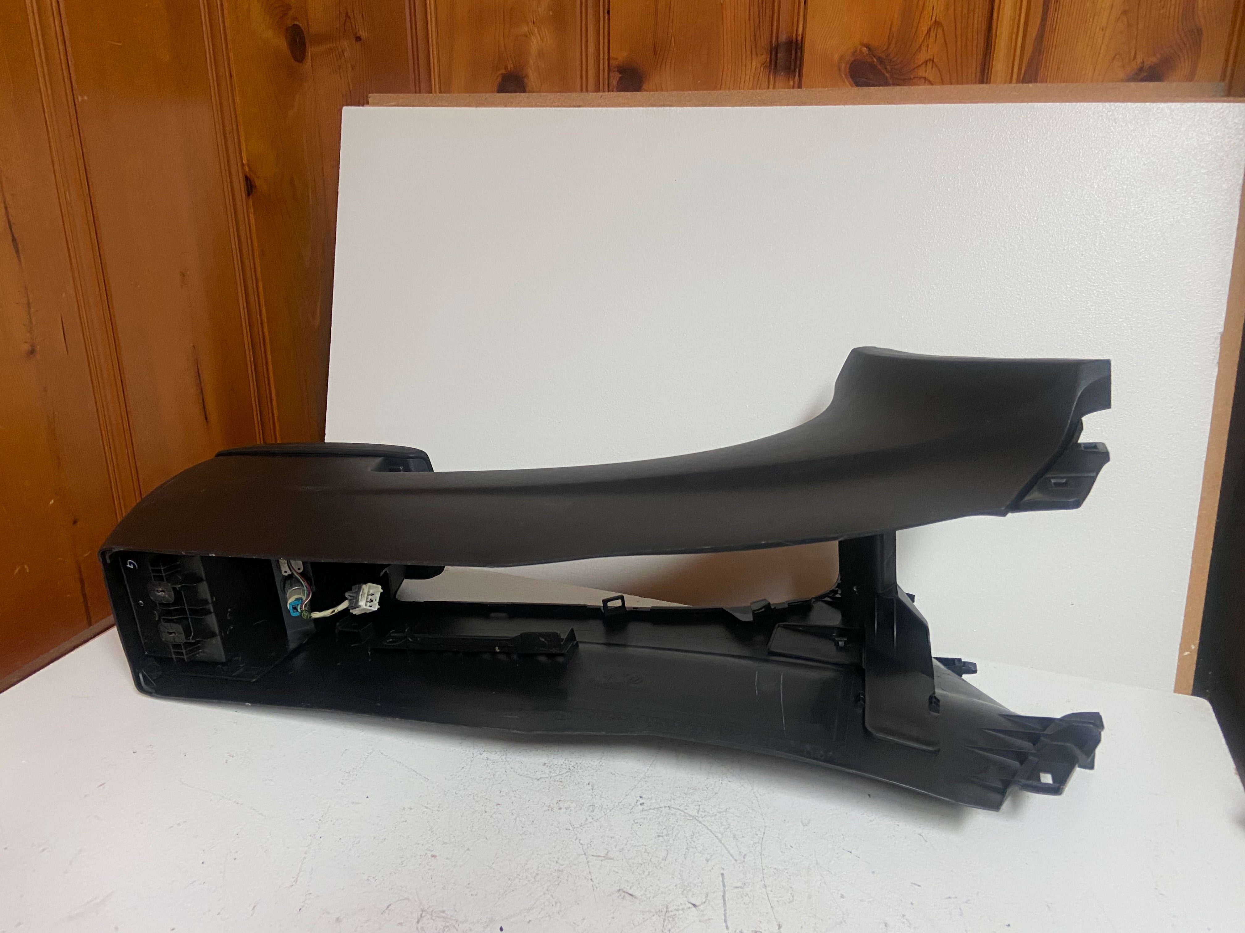 Black floor center console side with armrest and mounting brackets