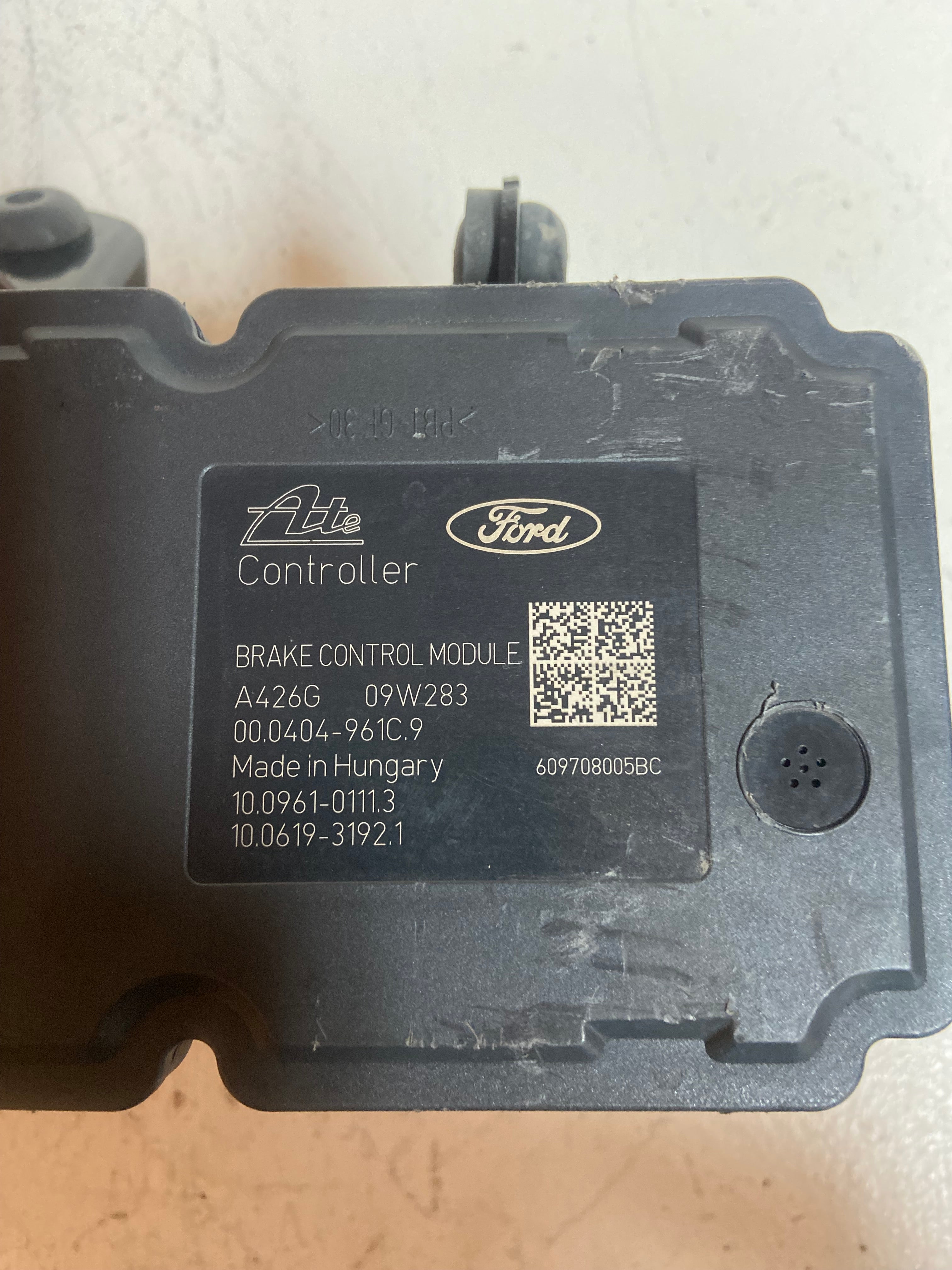 ABS brake control module with Ford and ATE logos on dark housing.