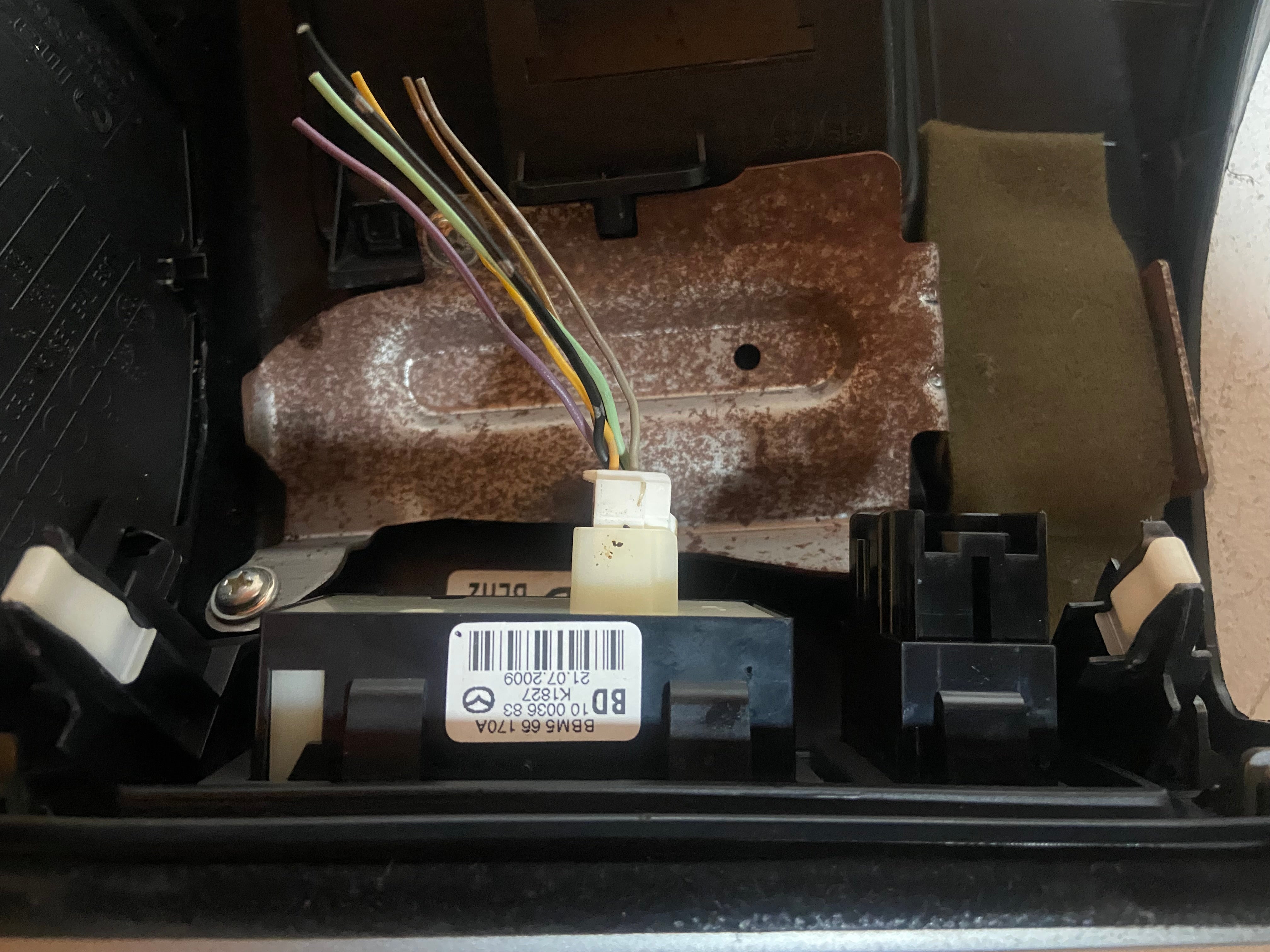 Black lower dash trim/knee kick panel with wiring connectors