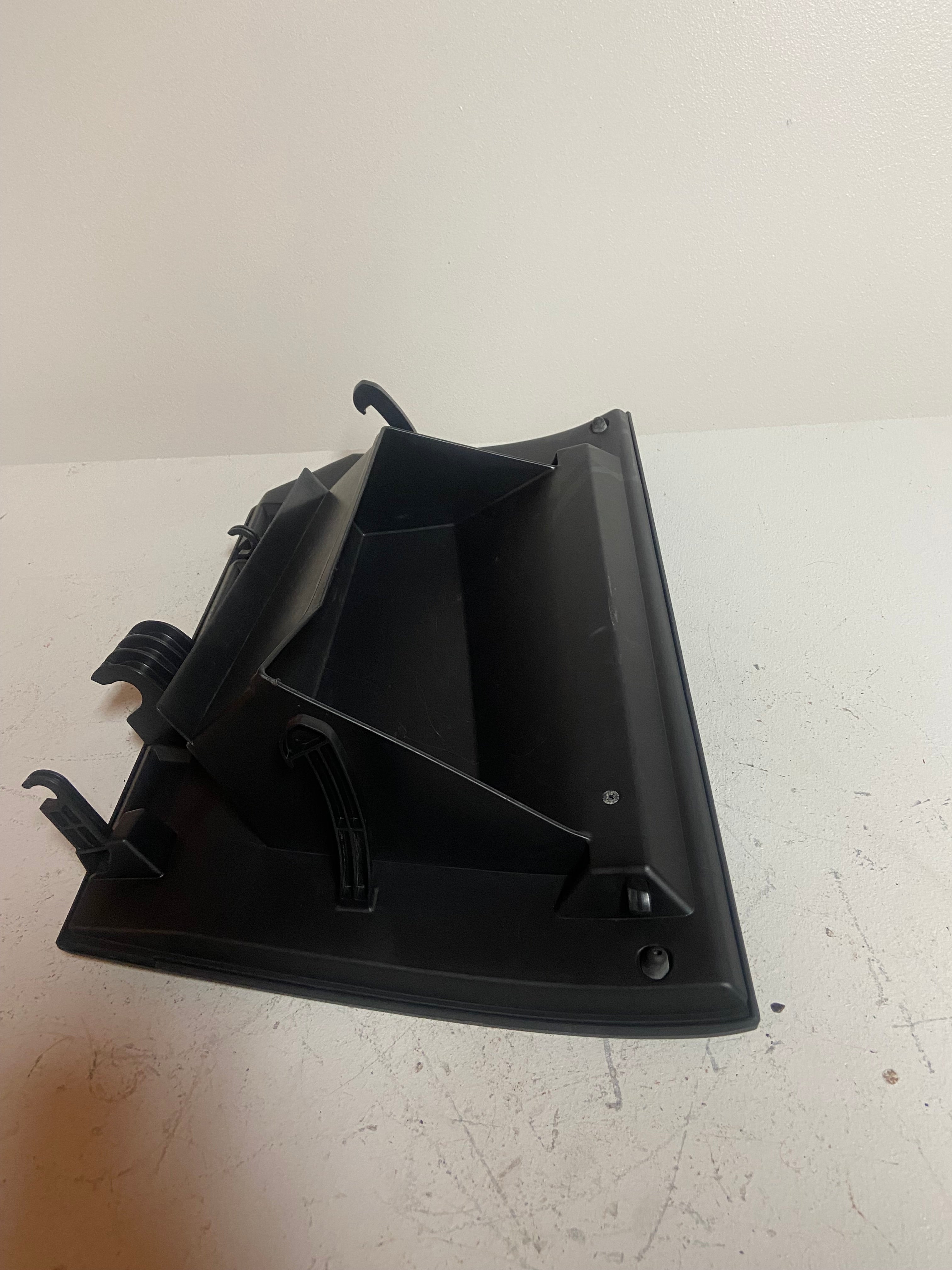 Black glove box lid assembly with molded supports and hinge points