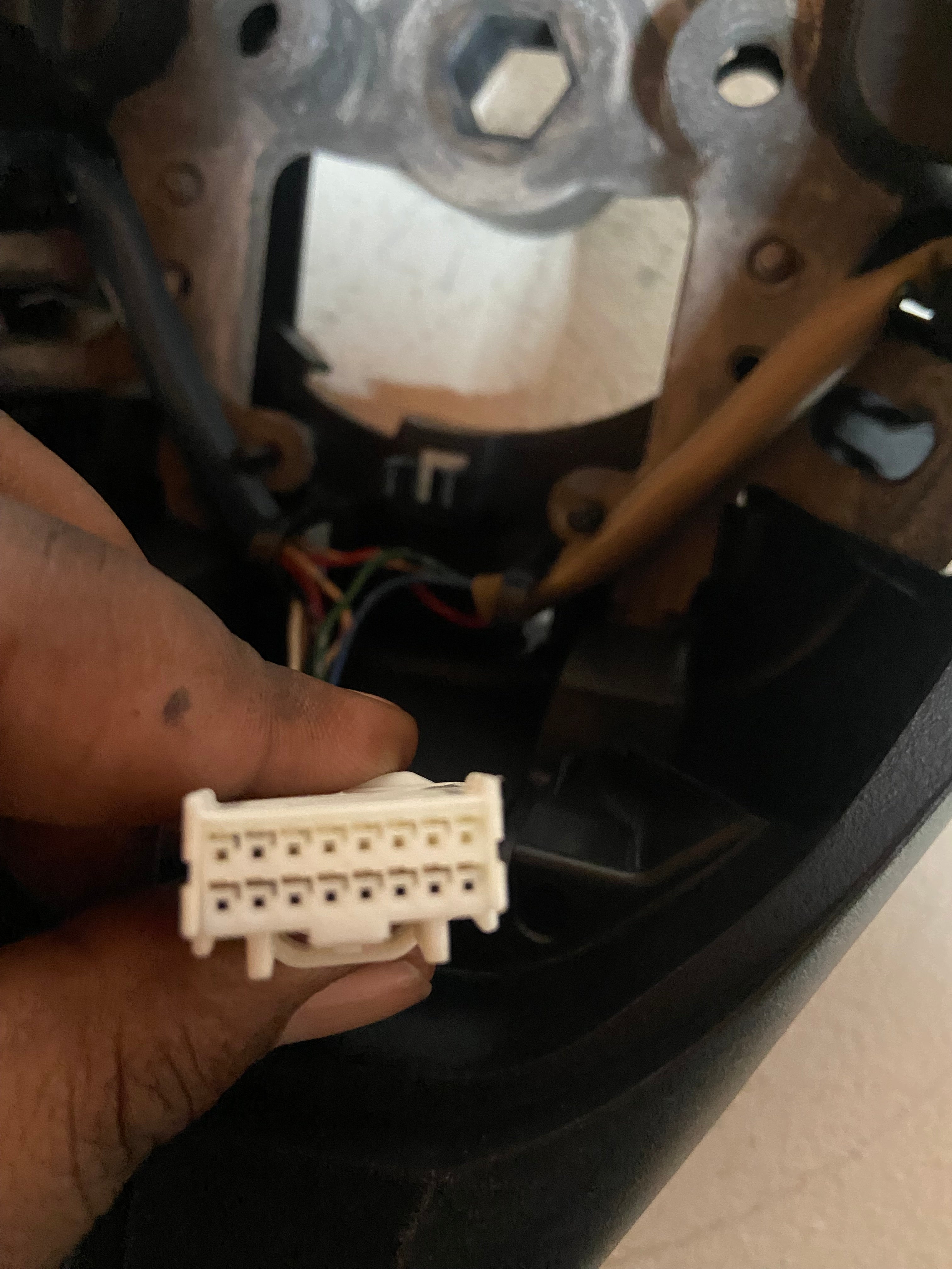Steering wheel wiring connector and harness plug, close-up inside the steering wheel
