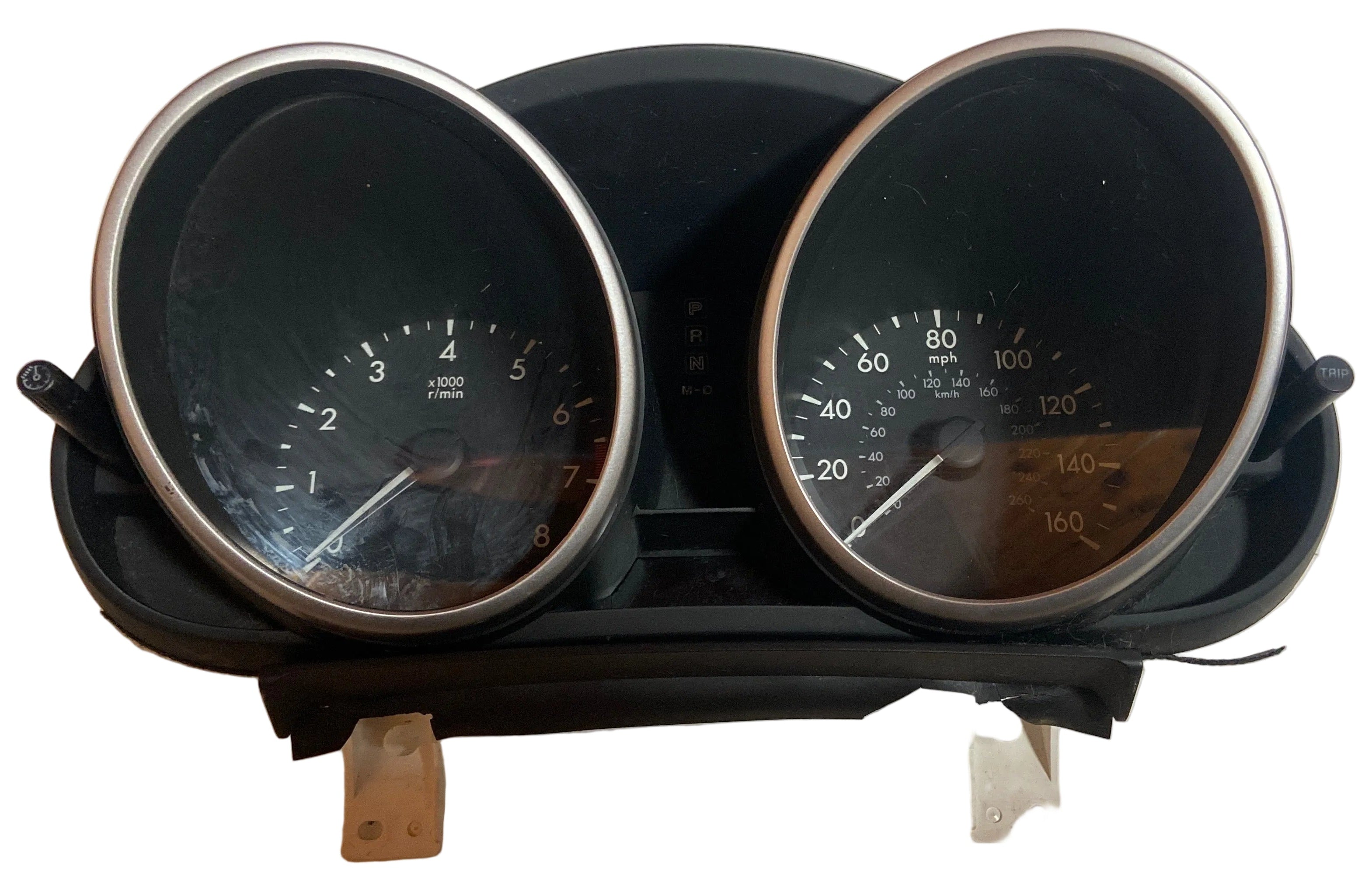 Vehicle instrument cluster with two analog gauges in black bezel housing