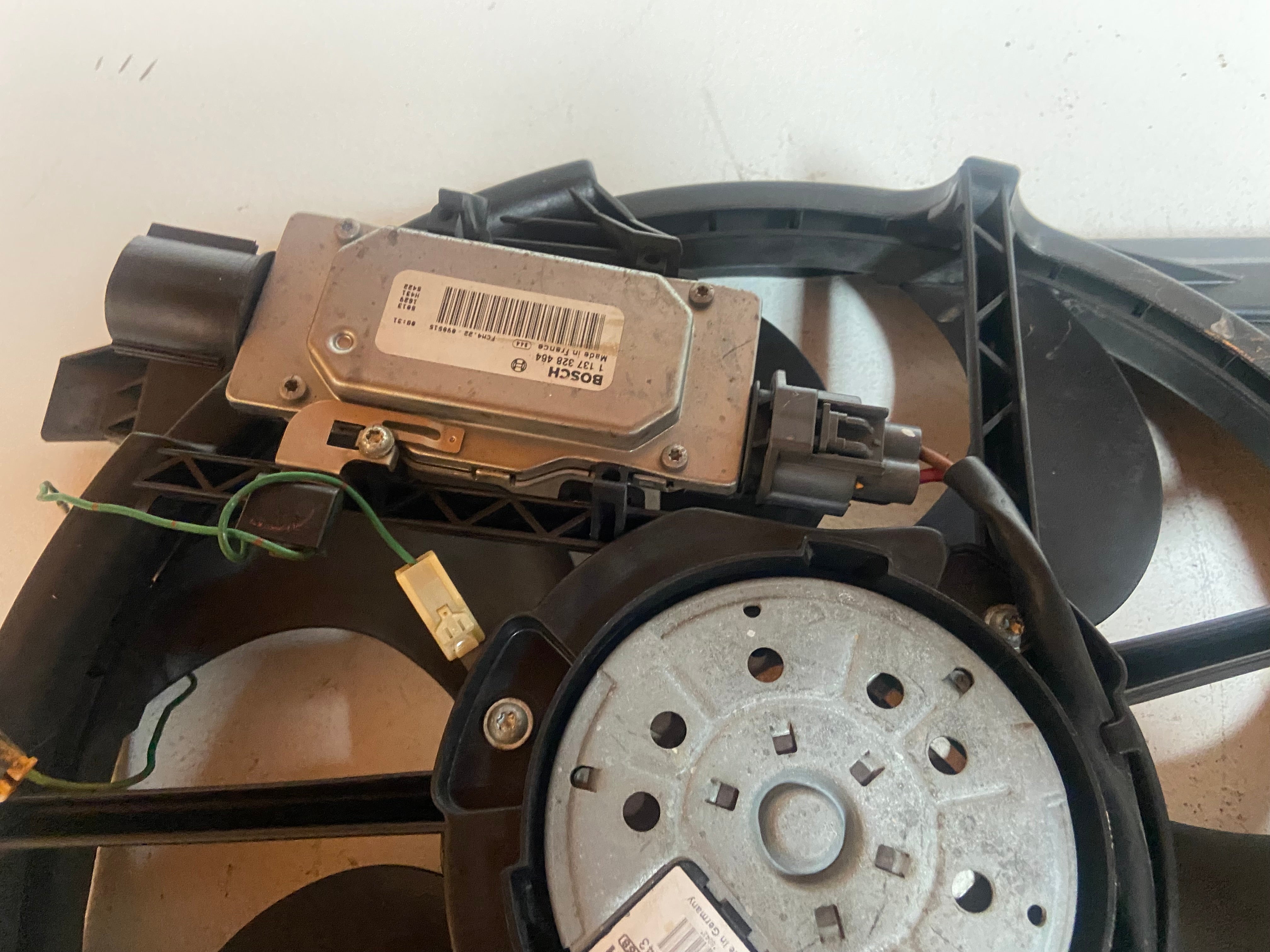 Electric radiator cooling fan assembly housing with circular fan and wiring