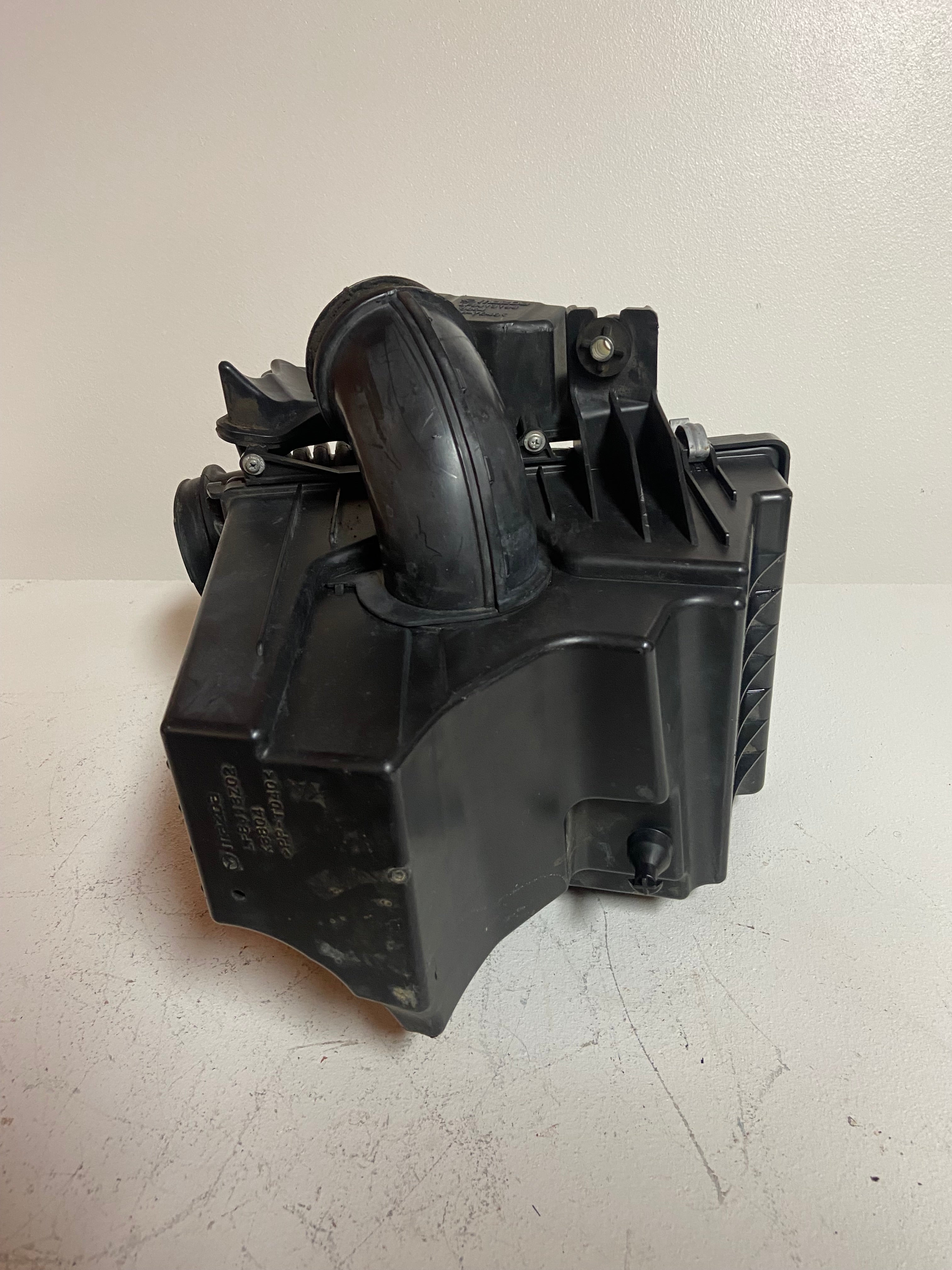 Black plastic engine air cleaner housing with intake duct and air intake tube