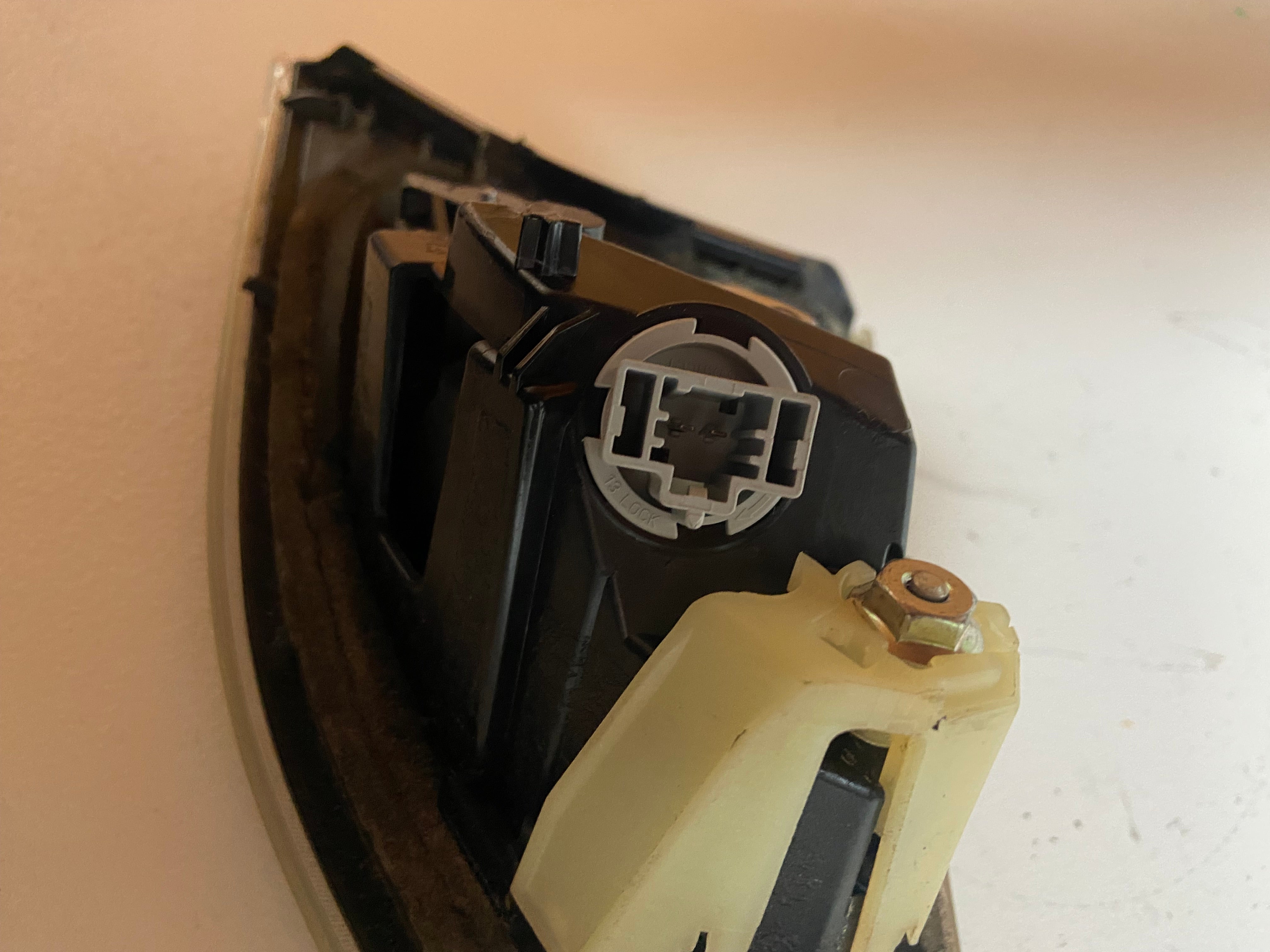 Left rear inner tail light/reverse lamp assembly, close-up of internal connector and lens