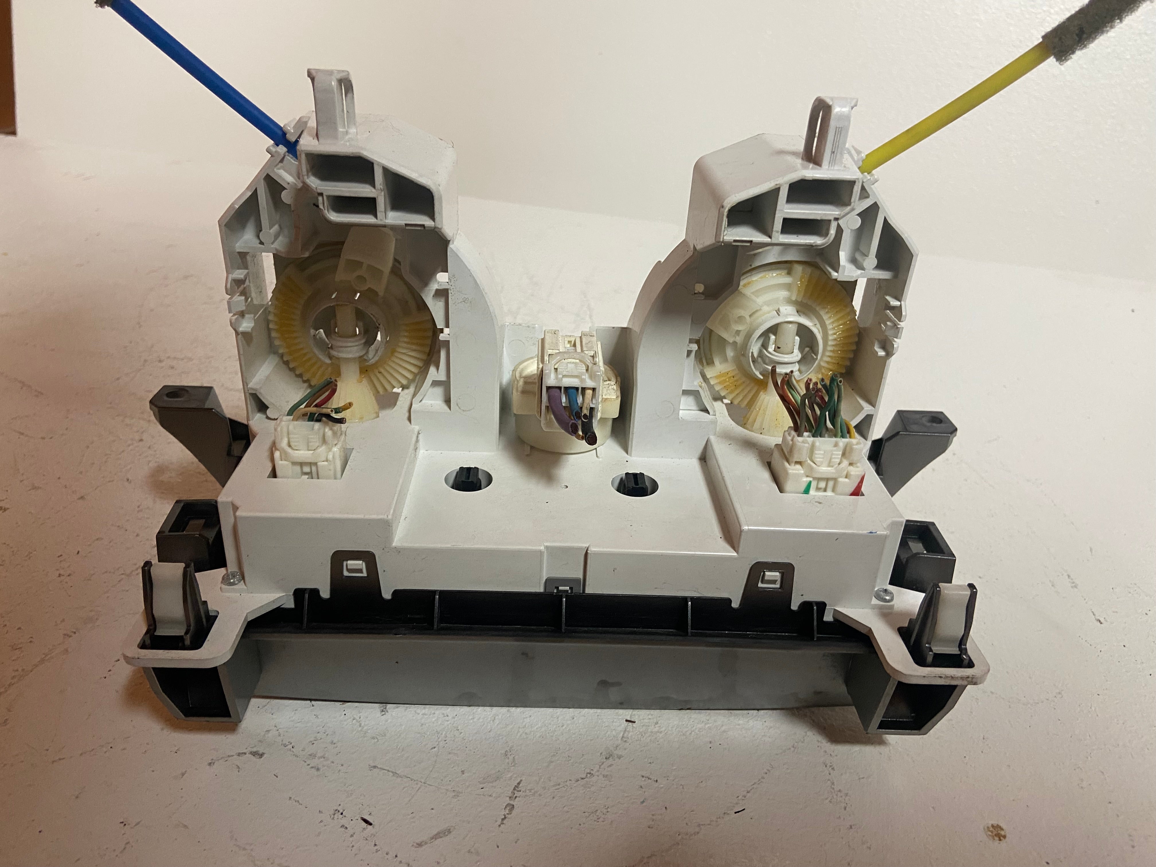 Climate control actuator module showing two motors and connector terminals with cables