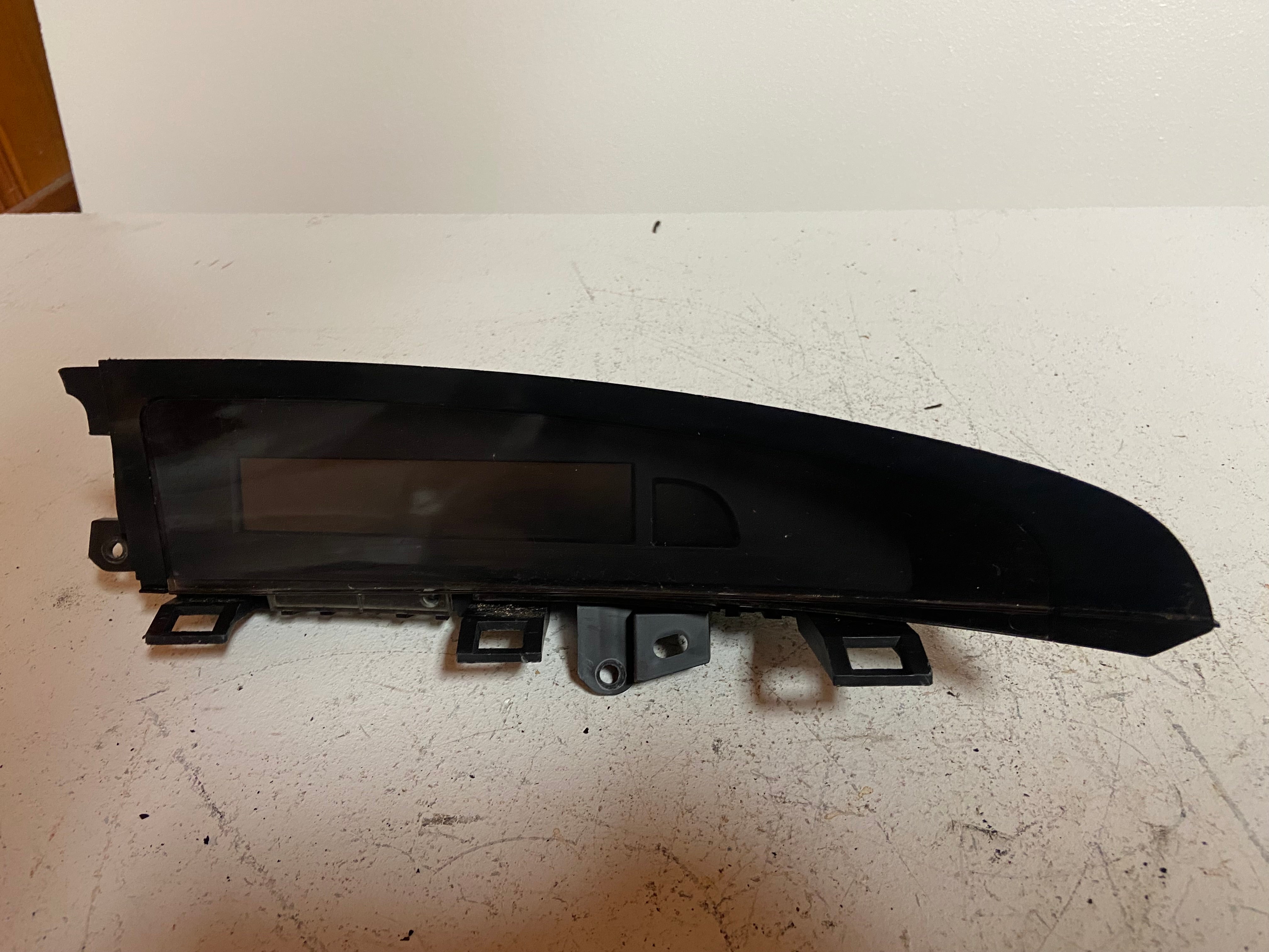 Black dash display screen bezel with dark window and mounting tabs