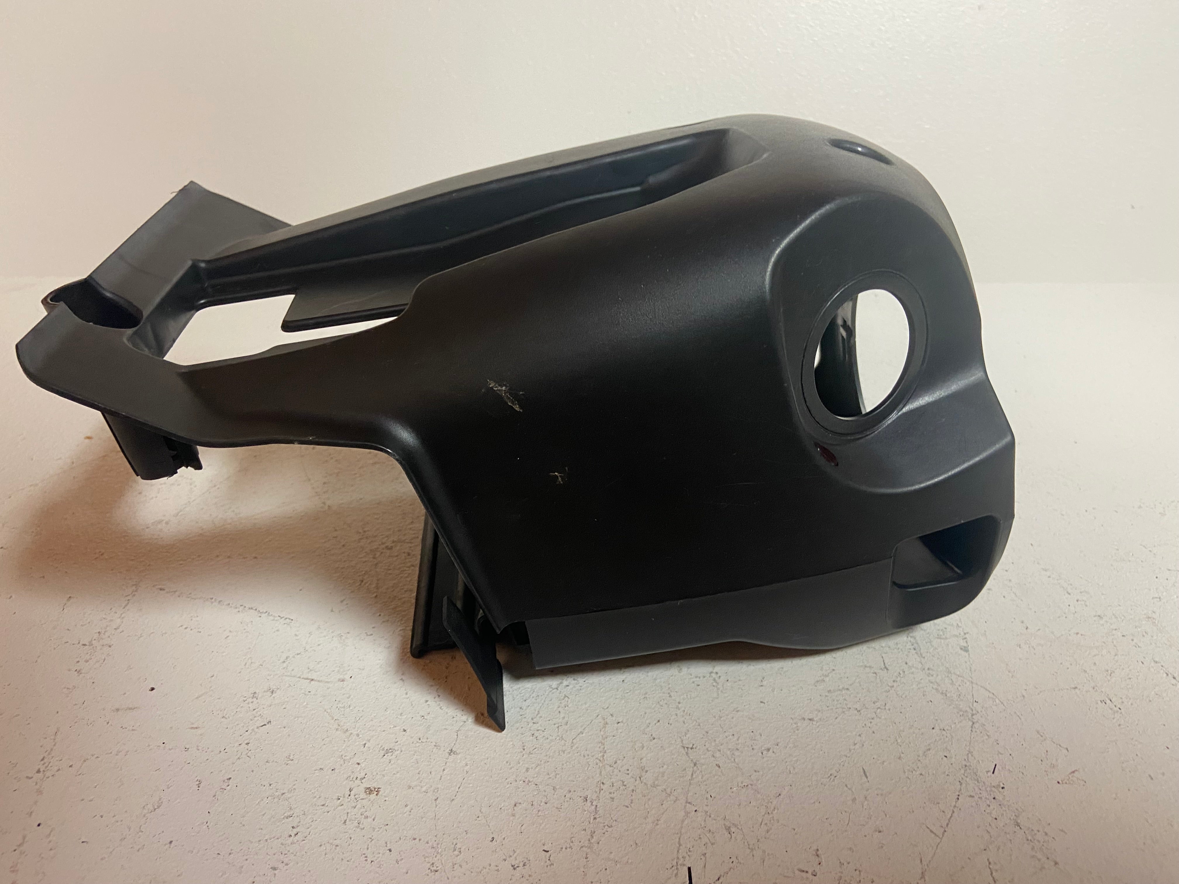 Black steering column shroud cover with round sensor-style hole opening