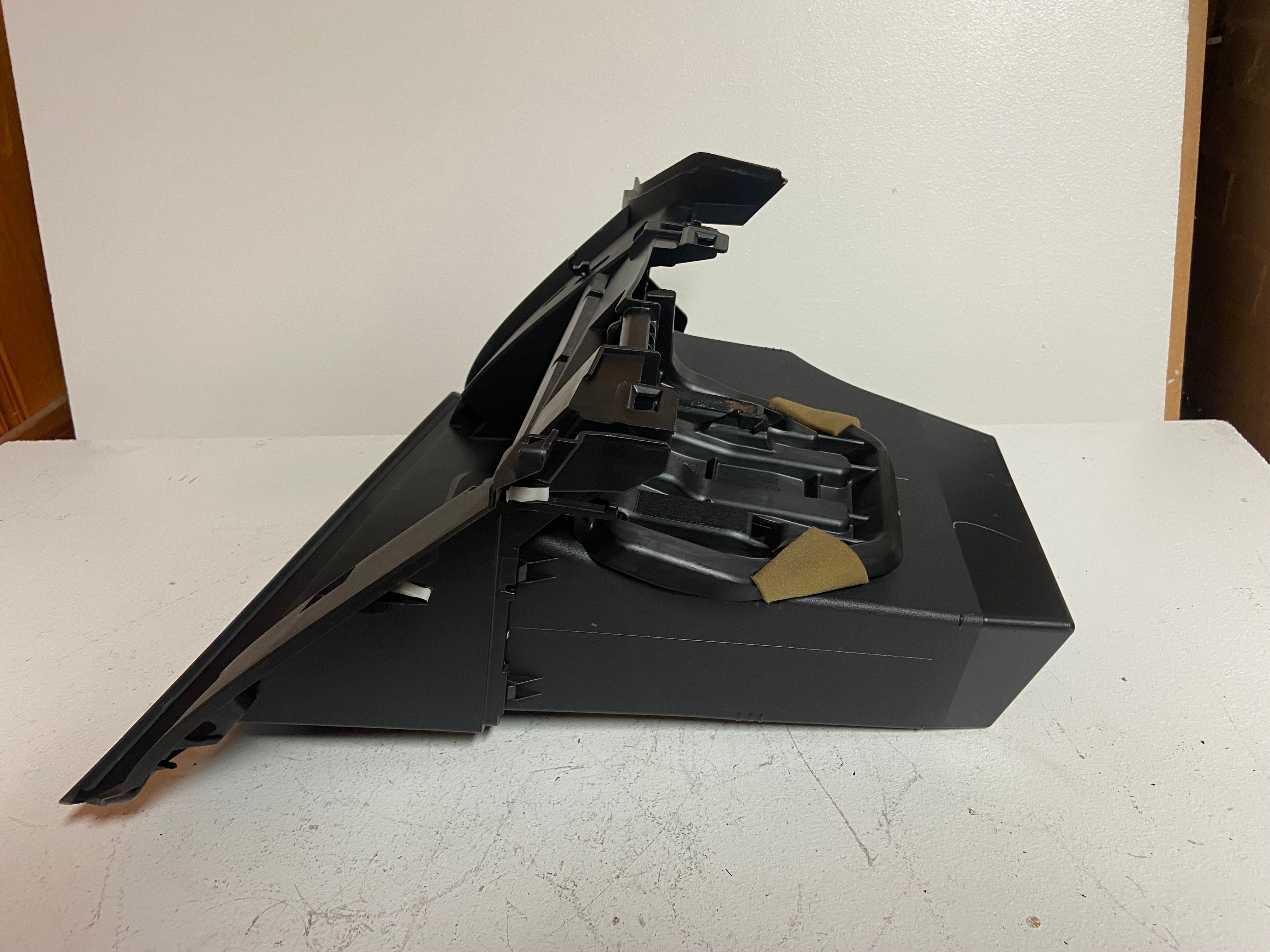 Black glove box compartment assembly with open tray and internal brackets
