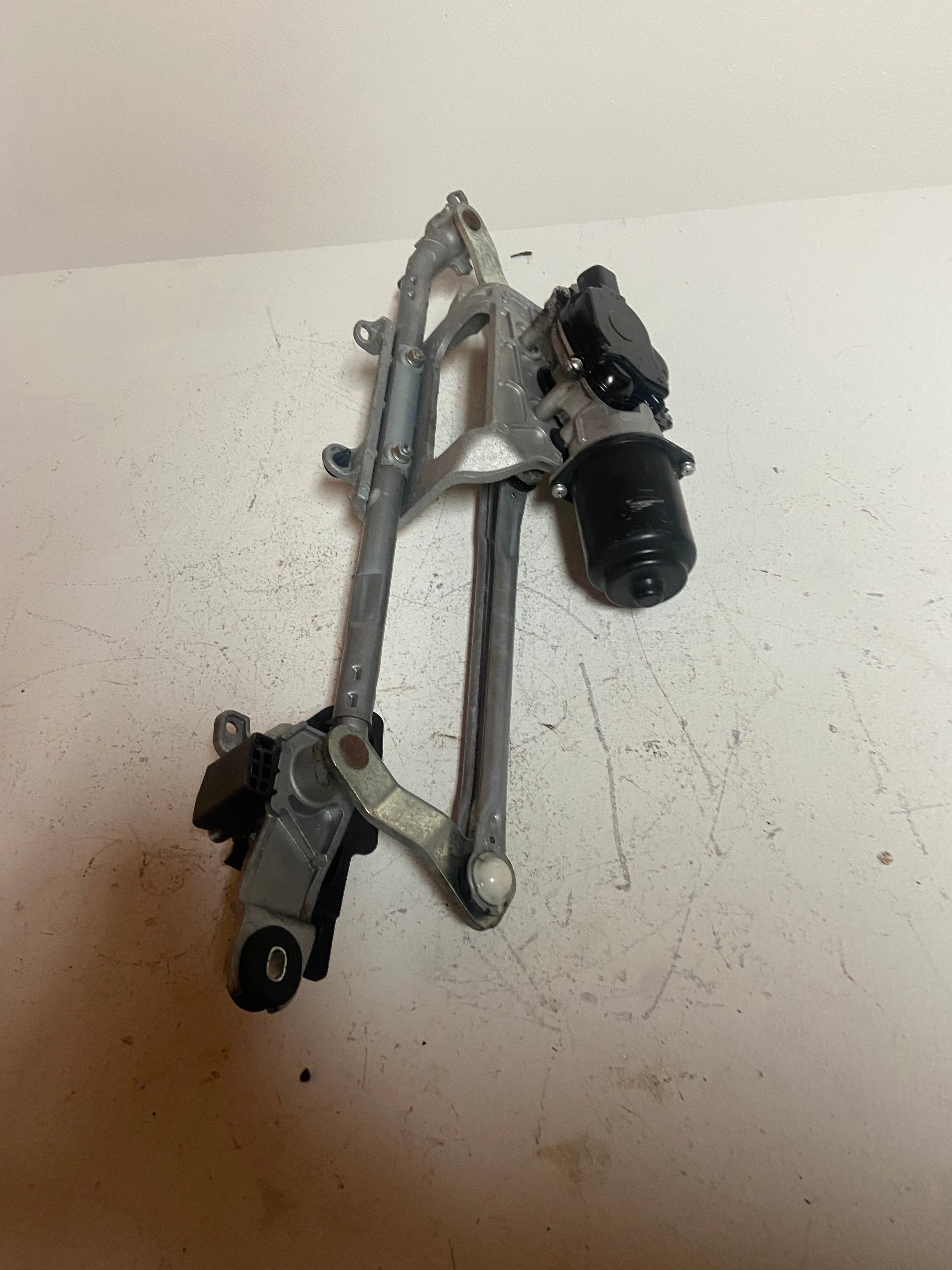 Windshield wiper motor linkage frame with black motor and wiper arm mounts