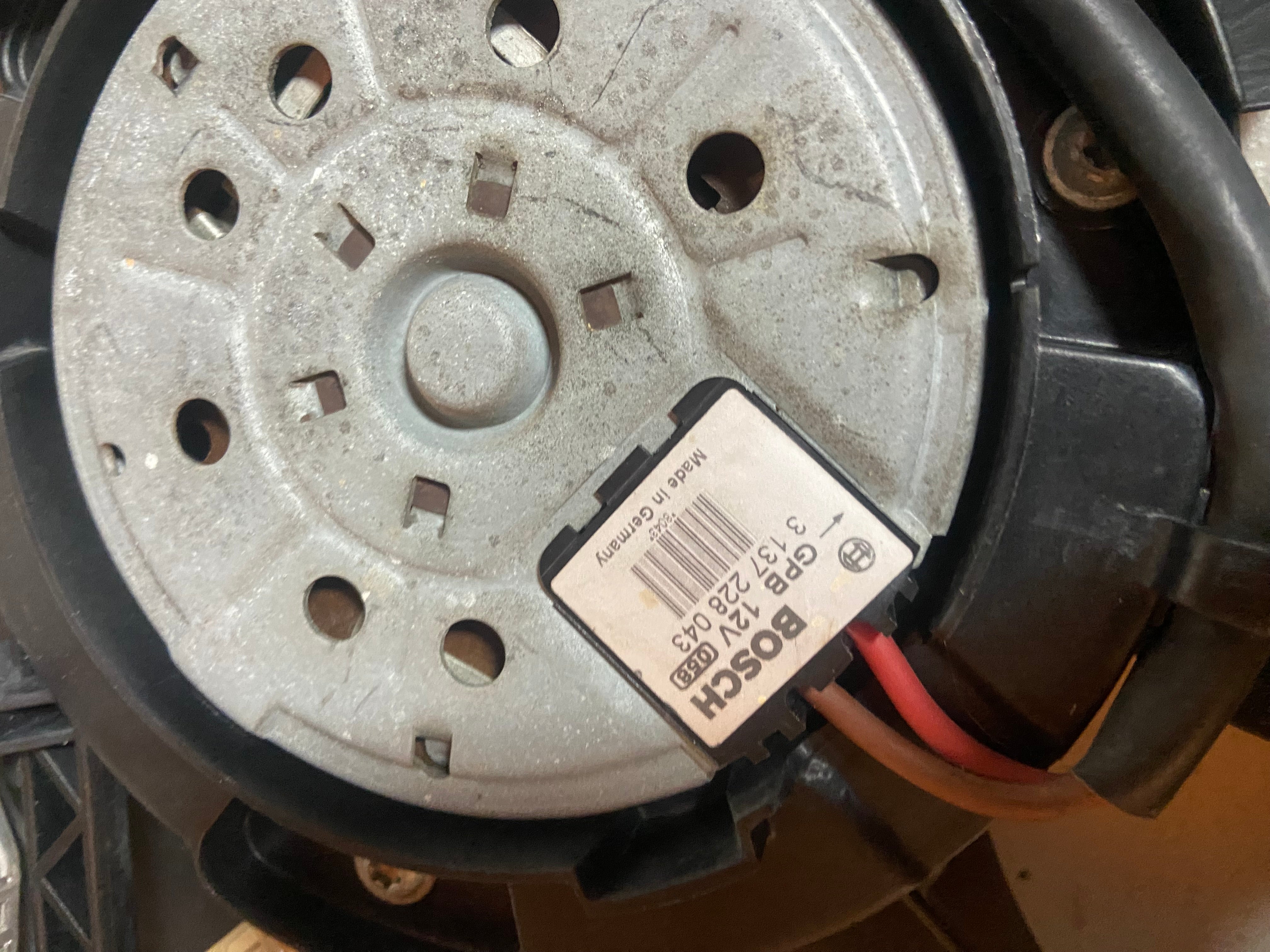 Electric radiator cooling fan motor with round metal plate and wiring connector