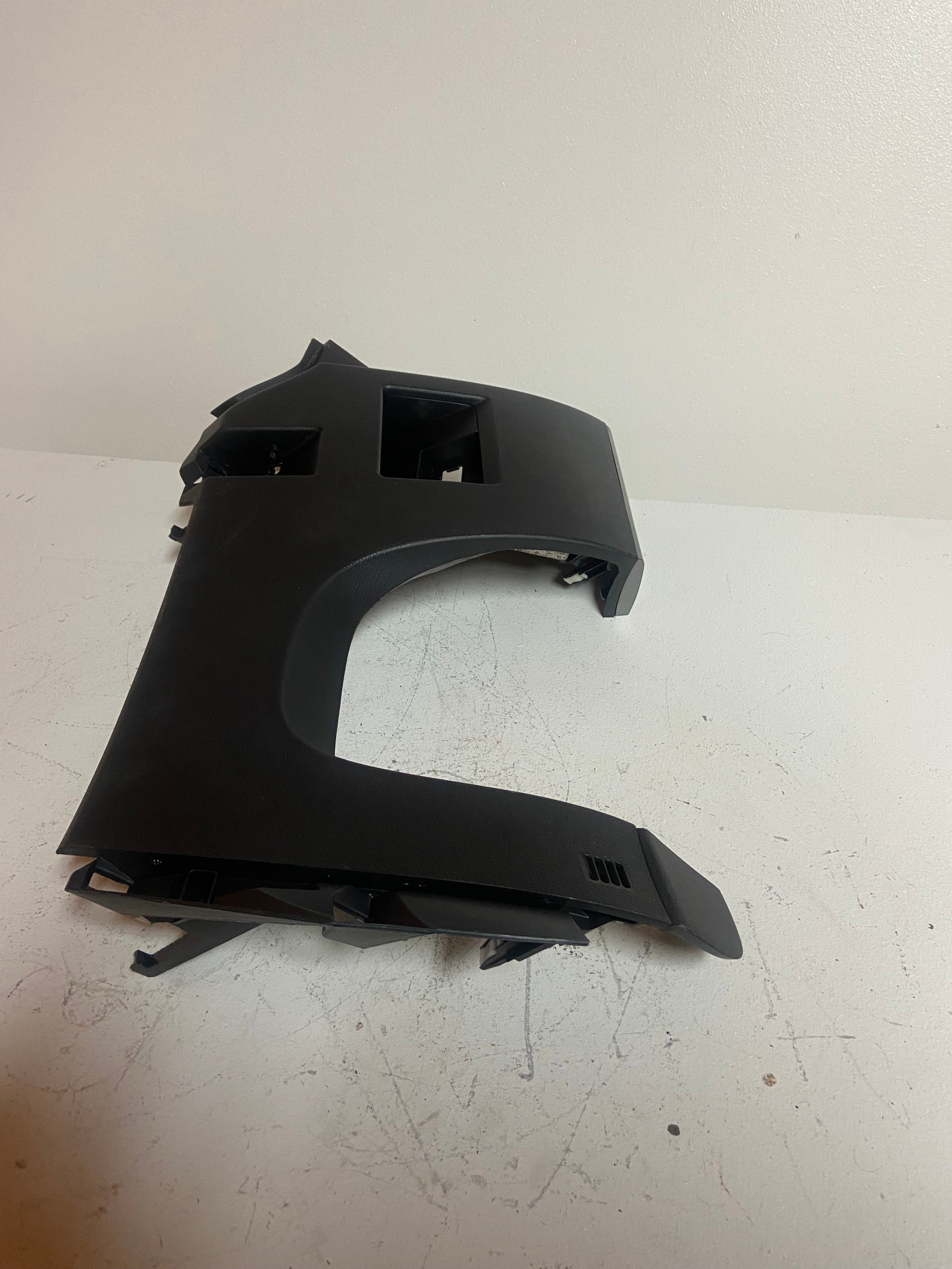 Black curved dash trim panel cover with side mounting tabs