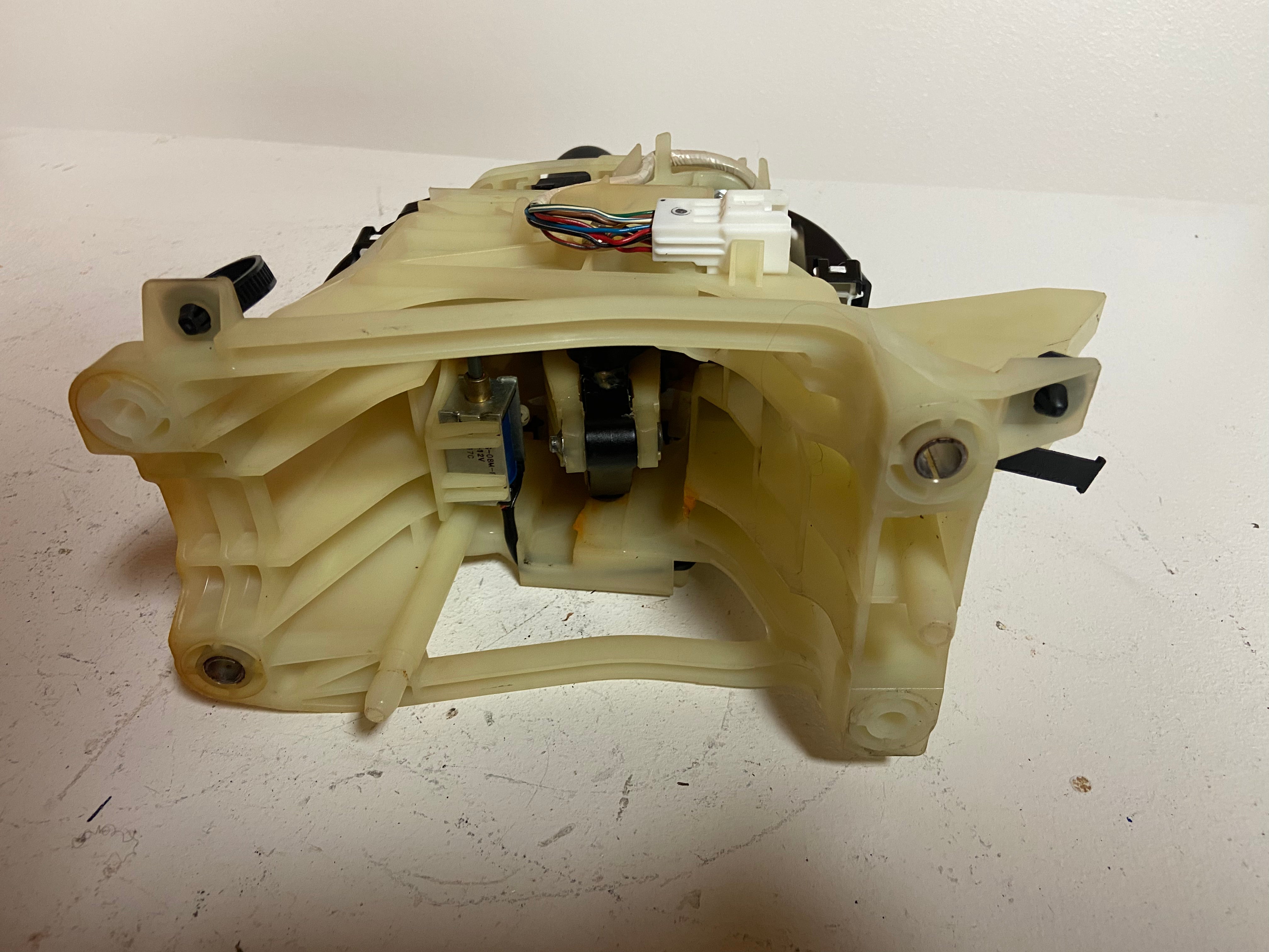 Beige plastic automatic transmission shifter assembly housing with electrical connector