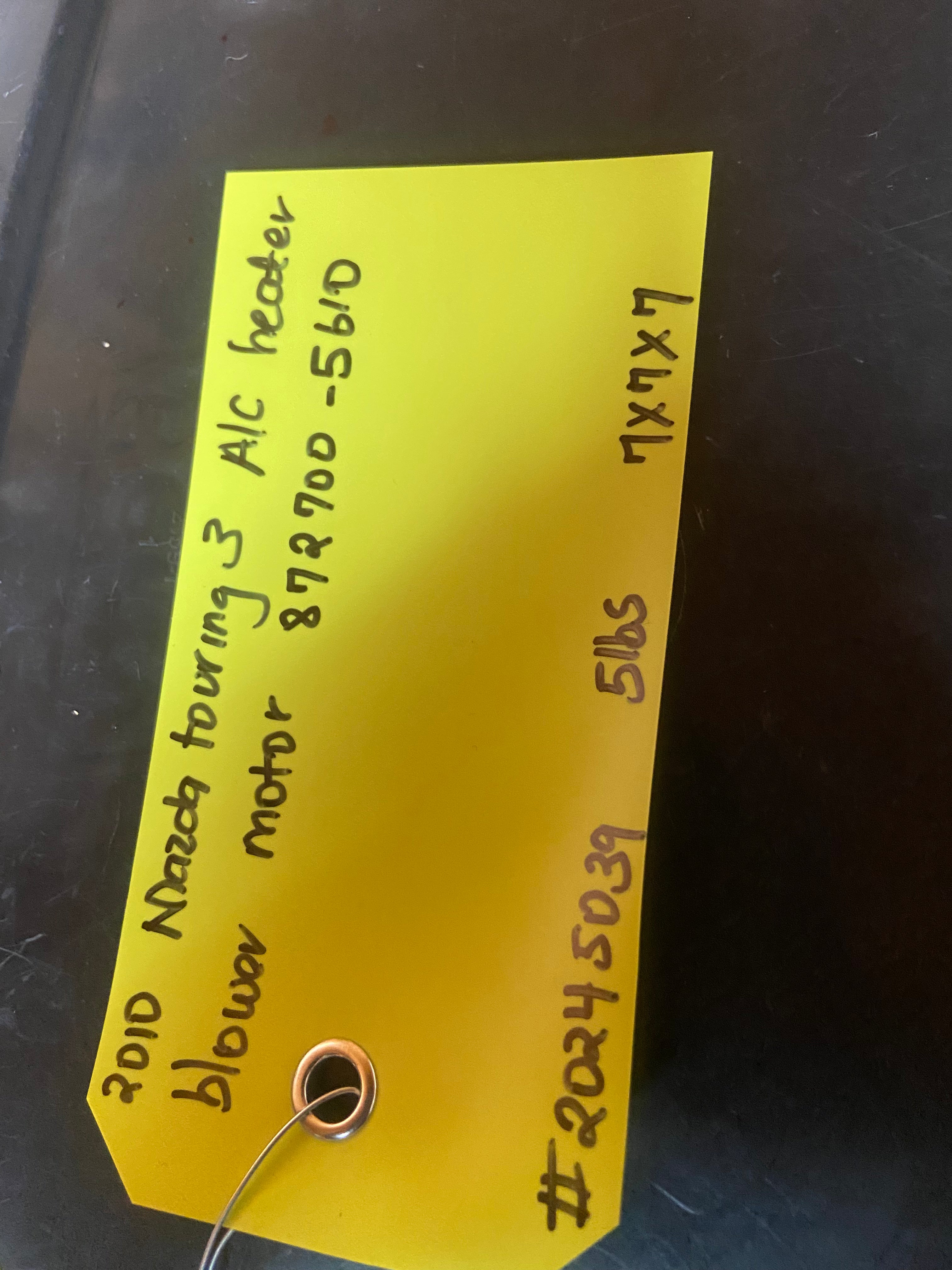 A/C heater blower motor with circular copper contact and yellow inventory label
